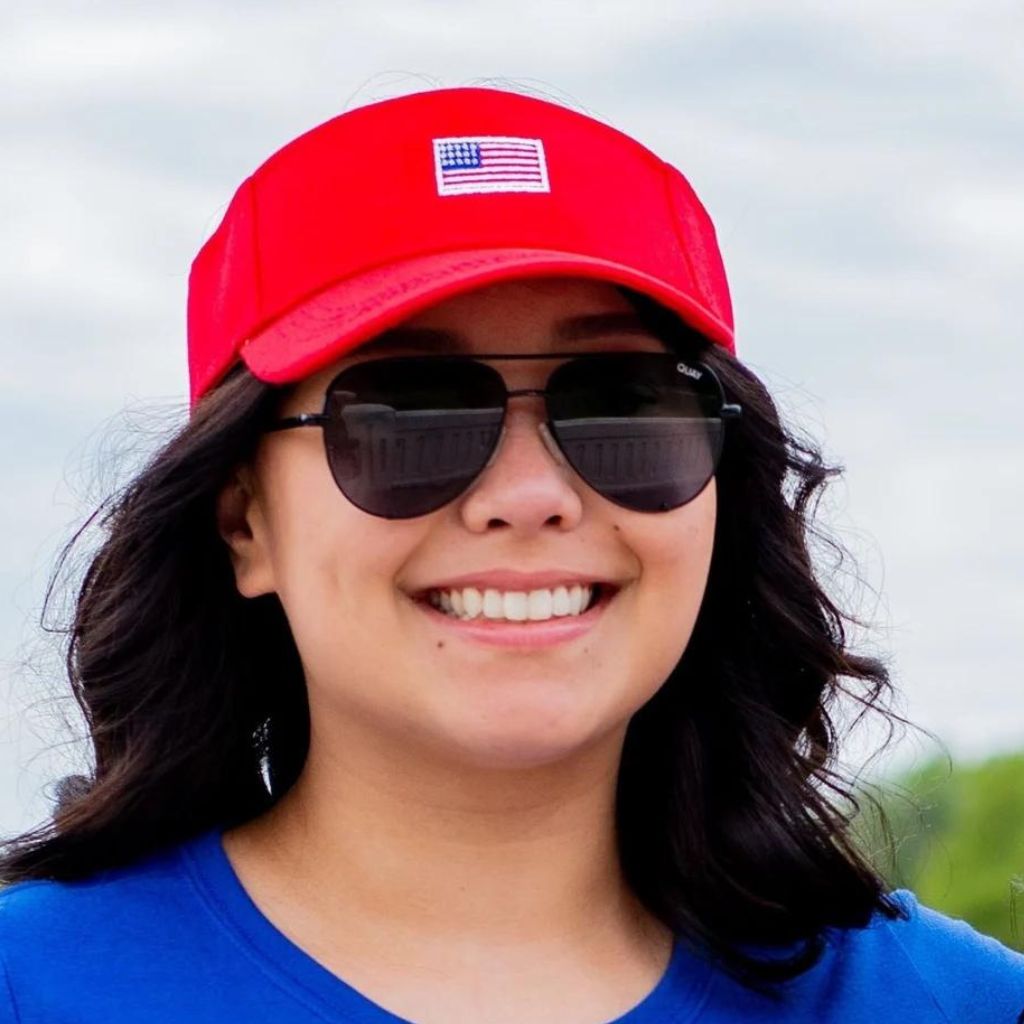 Female wearing a red visor embroidered with a USA Flag