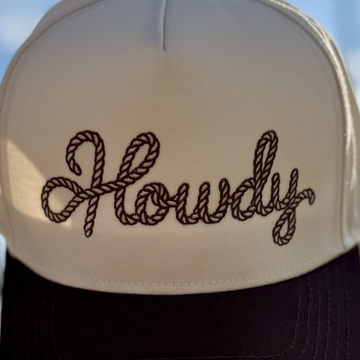 Close-up of the rope-style Howdy script embroidery on the Howdy Rope trucker hat