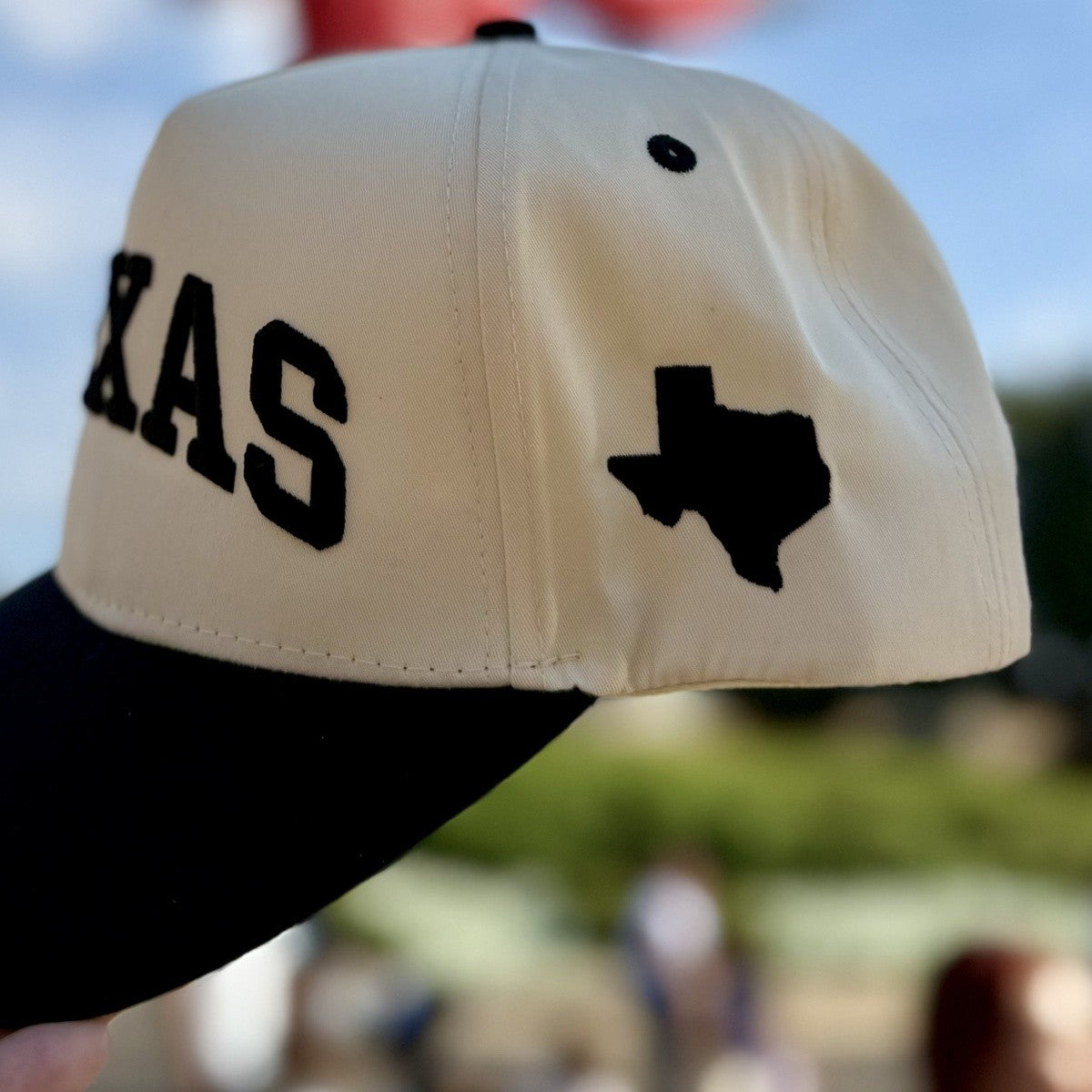 Close-up of the embroidered Texas silhouette on the side of the Texas Varsity trucker hat