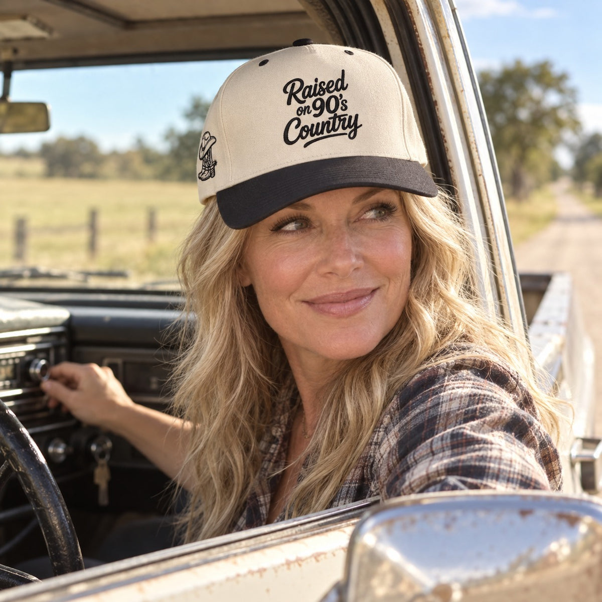 Woman in an old pickup truck wearing the Raised on 90&