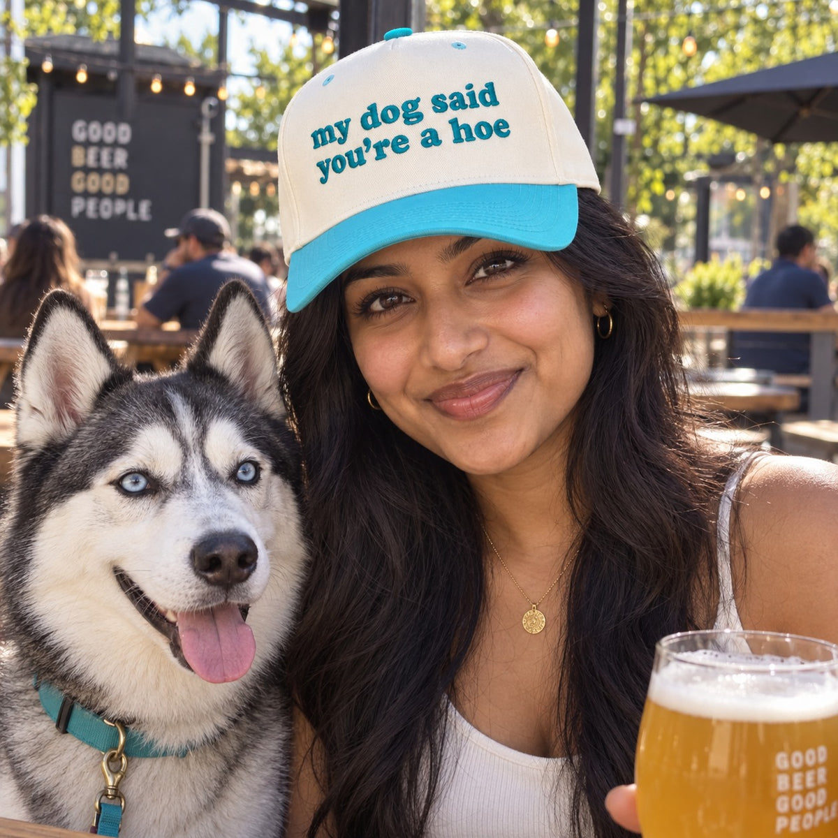 Woman on a brewery patio with a husky wearing the My Dog Said You&