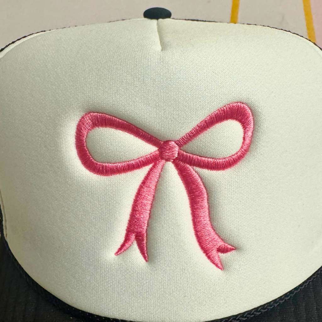 Close up of the Black foam trucker hat with an embroidered Pink Coquette Bow - DSY Lifestyle