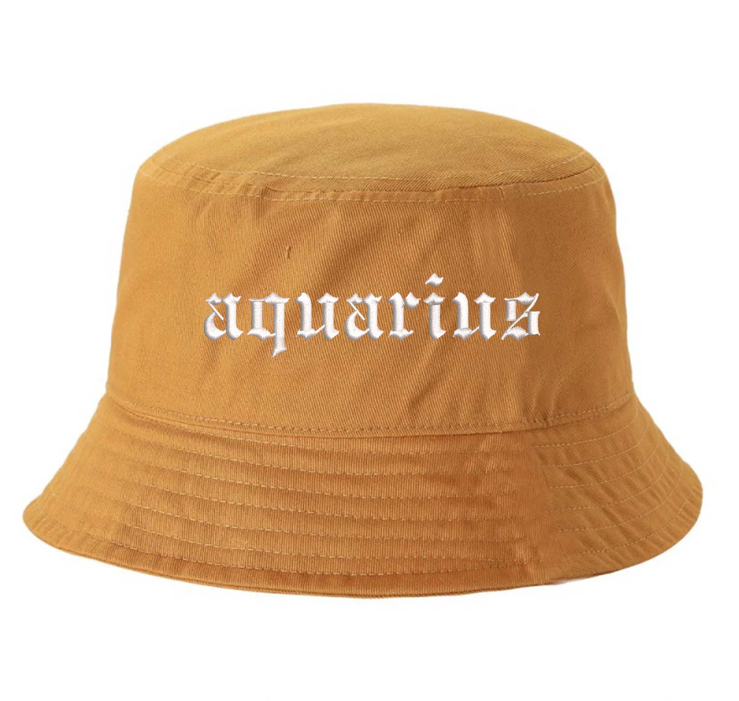 Mustard Aquarius Bucket Hat, a zodiac statement hat designed for bold individuality and expressive everyday style. DSY Lifestyle.