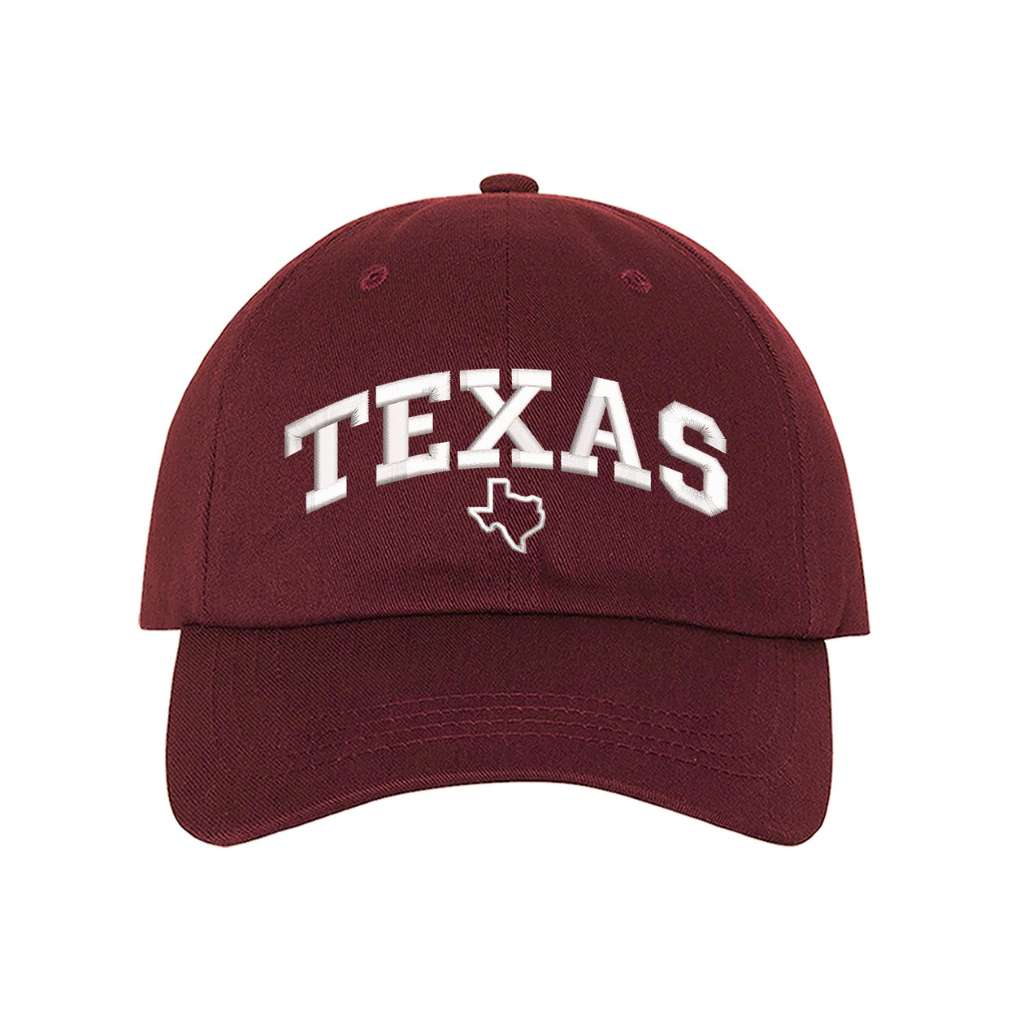 Burgundy baseball hat embroidered with the word texas and a small map of texas underneath the word- DSY Lifestyle