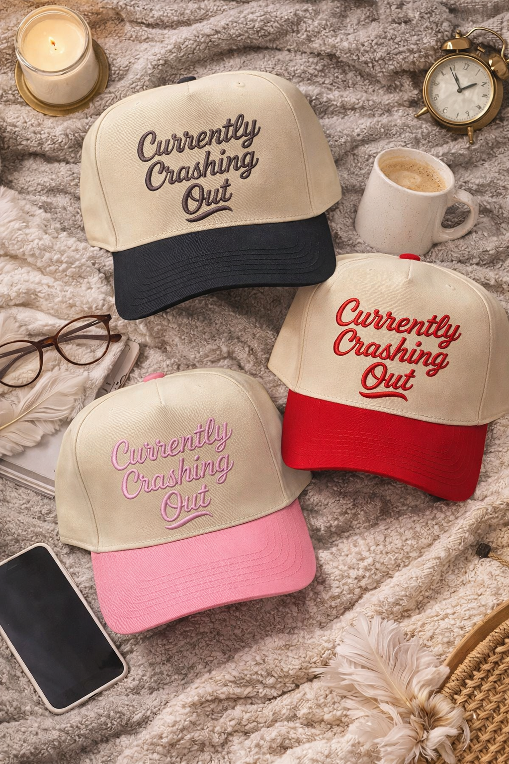 Flat lay or Natural Black, Natural Light Pink and Natural Red Currently Crashing Out embroidered baseball hats. A two-tone statement hat for women who love humor, comfort, and effortless outfits. - DSY Lifestyle