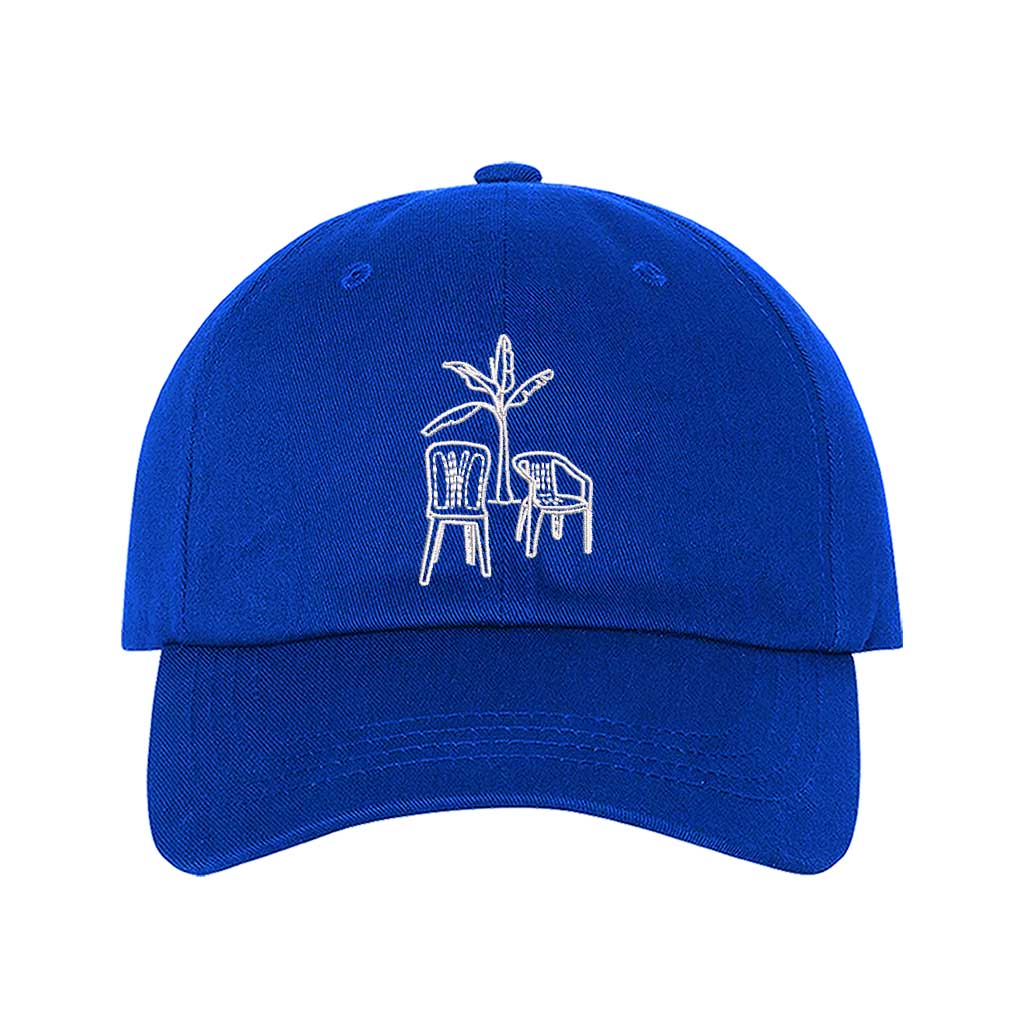Front the DTMF Debi Tirar Mas Fotos royal blue dad cap featuring an embroidered banana tree with two chairs, inspired by Bad Bunny&