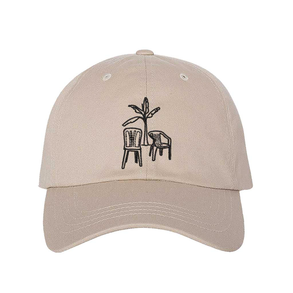 Front the DTMF Debi Tirar Mas Fotos stone dad cap featuring an embroidered banana tree with two chairs, inspired by Bad Bunny&