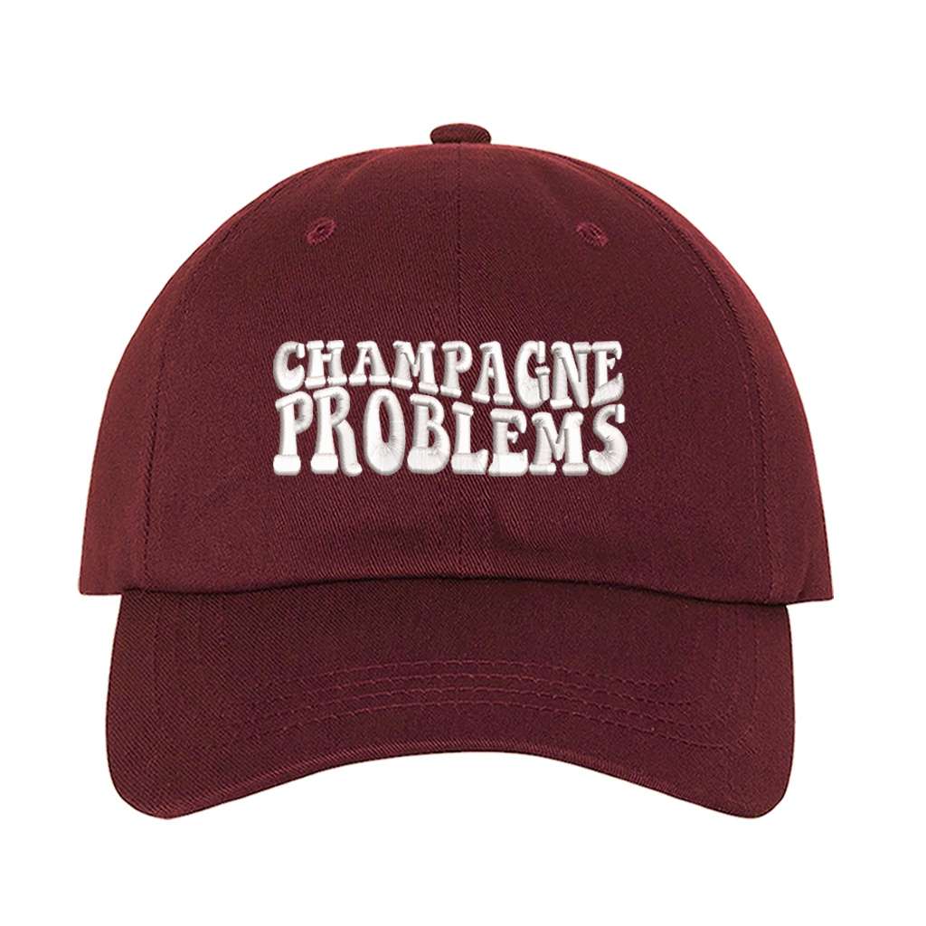 Burgundy baseball hat embroidered with the phrase champagne problems-DSY Lifestyle