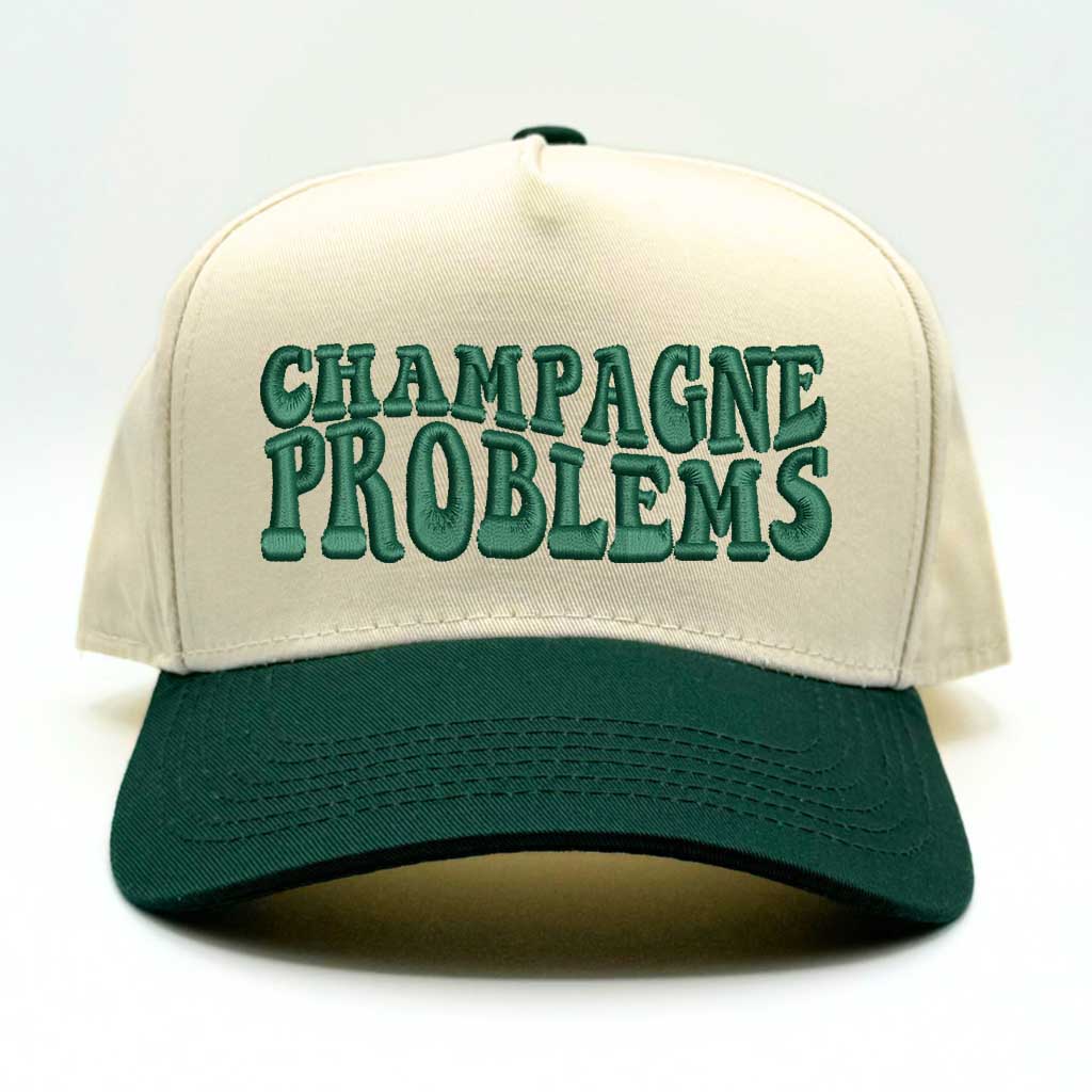 Natural color baseball hat with forest green bill and the phrase champagne problems in forest green embroidery-DSY Lifestyle