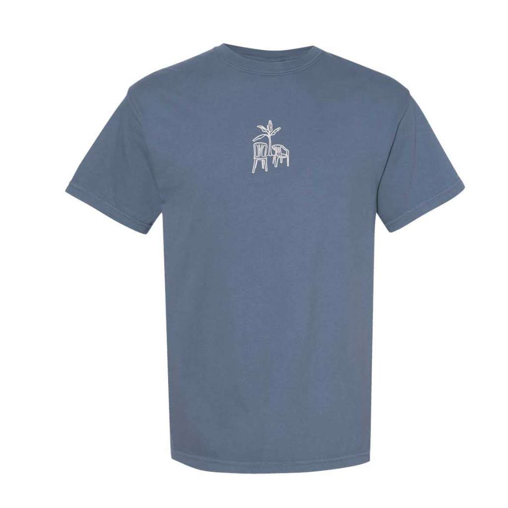 Blue jean Comfort Colors washed oversized t-shirt by DSY Lifestyle featuring a white DTMF embroidery of a platano tree with two chairs in the center.