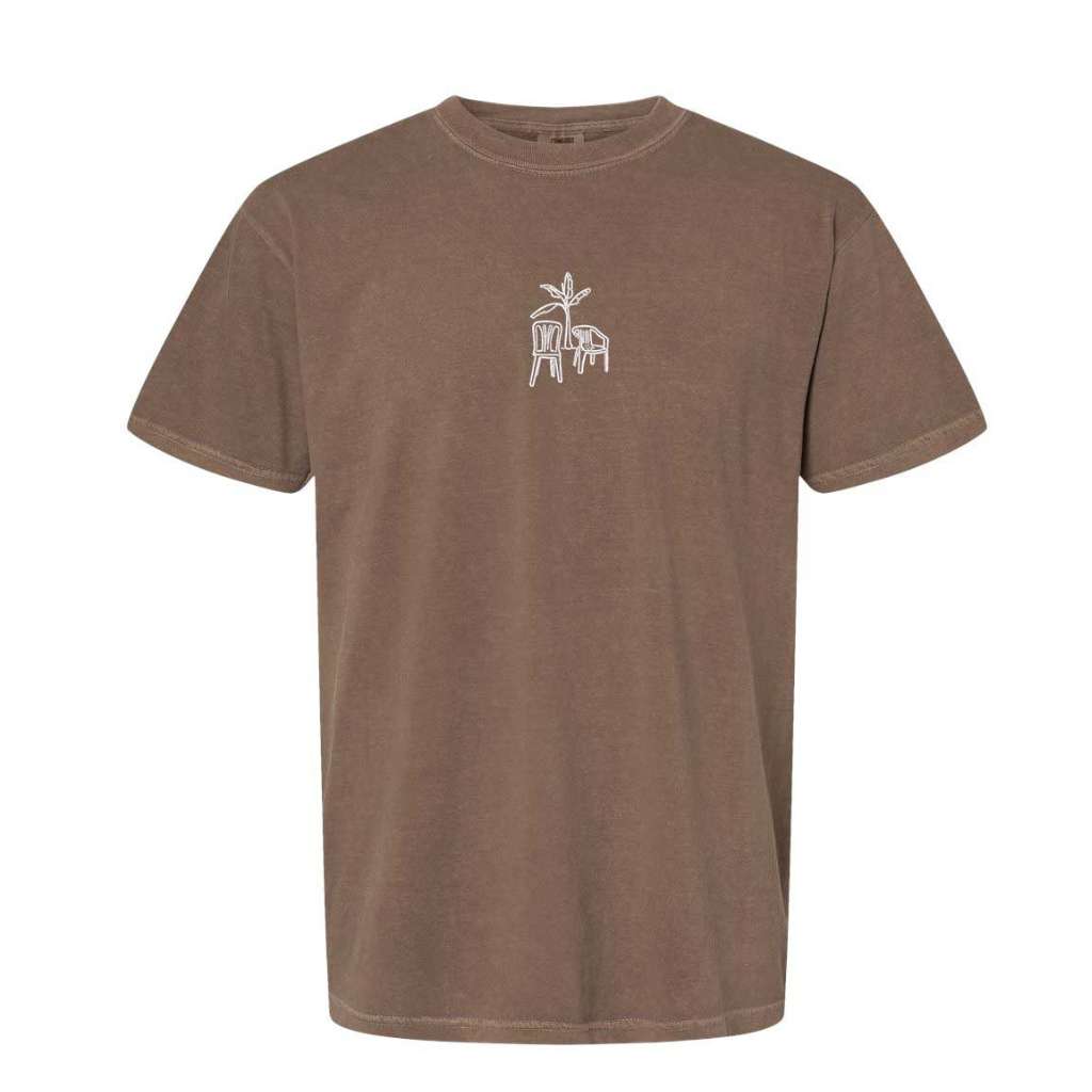 Brown Comfort Colors washed oversized t-shirt from DSY Lifestyle with a clean white DTMF embroidery of a platano tree and two chairs on the chest.