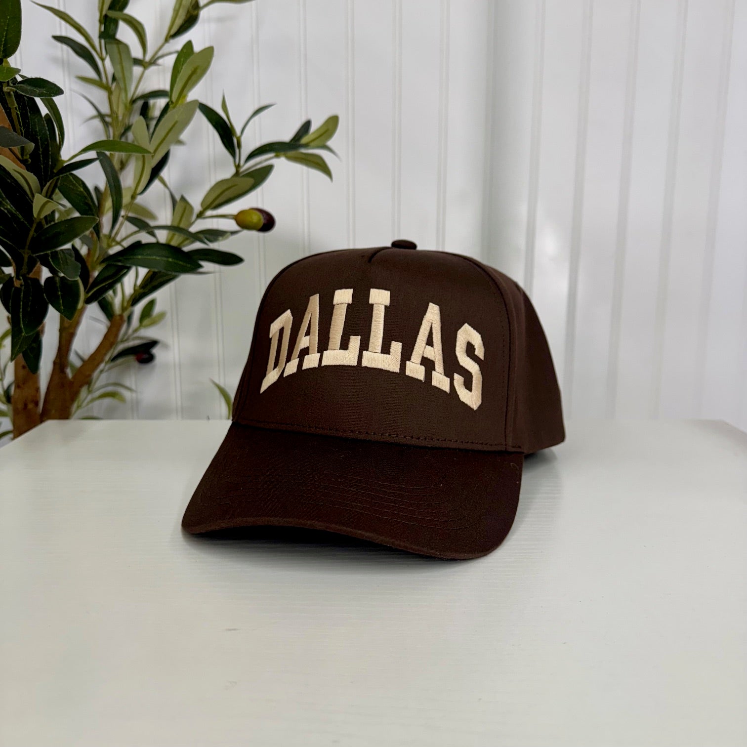 Brown 5-panel baseball hat featuring “Dallas” embroidered in bold lettering, offering a modern yet classic streetwear look - DSY Lifestyle