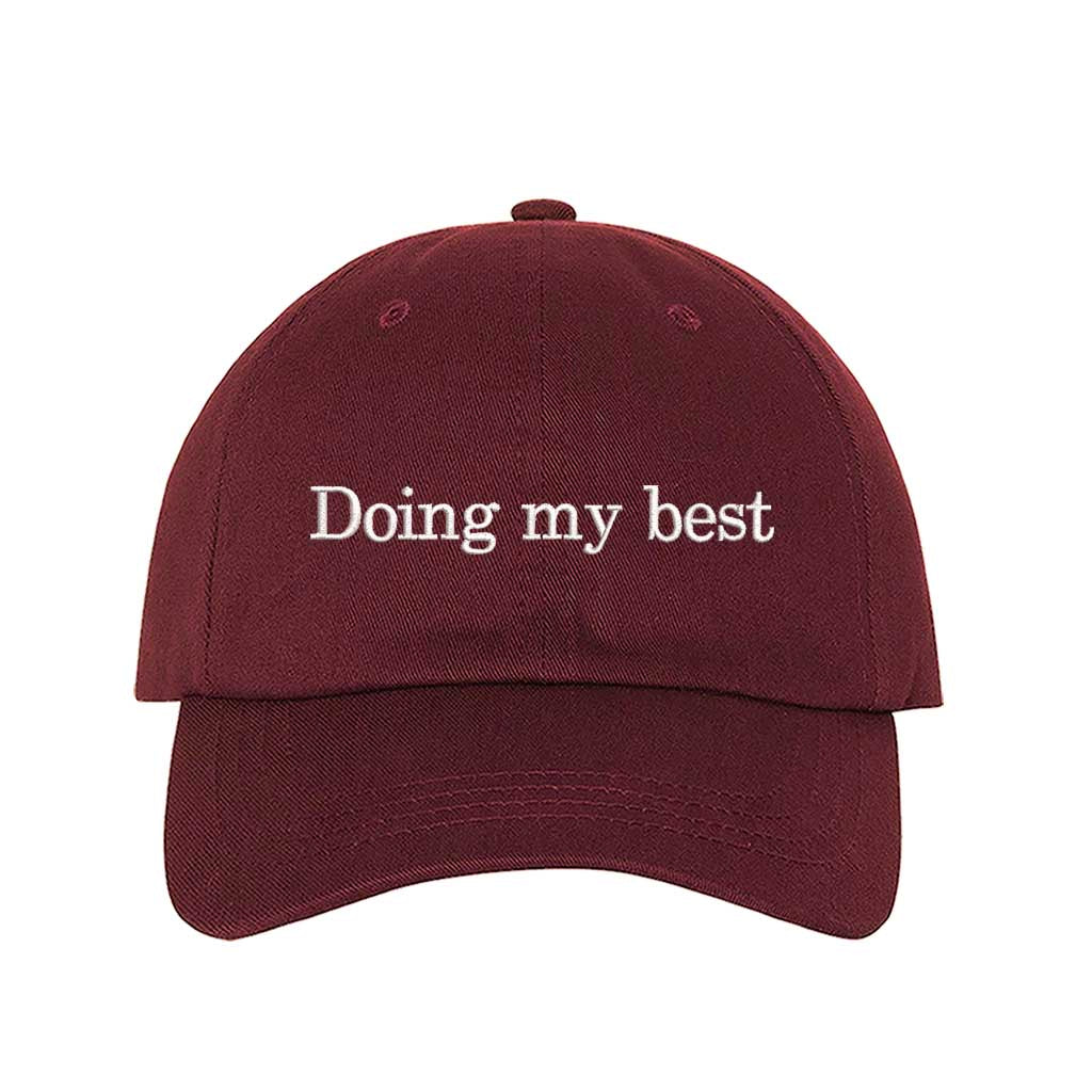 Burgundy close-up view of a DSY Lifestyle cotton baseball hat featuring the words Doing My Best in detailed professional embroidery. - DSY Lifestyle