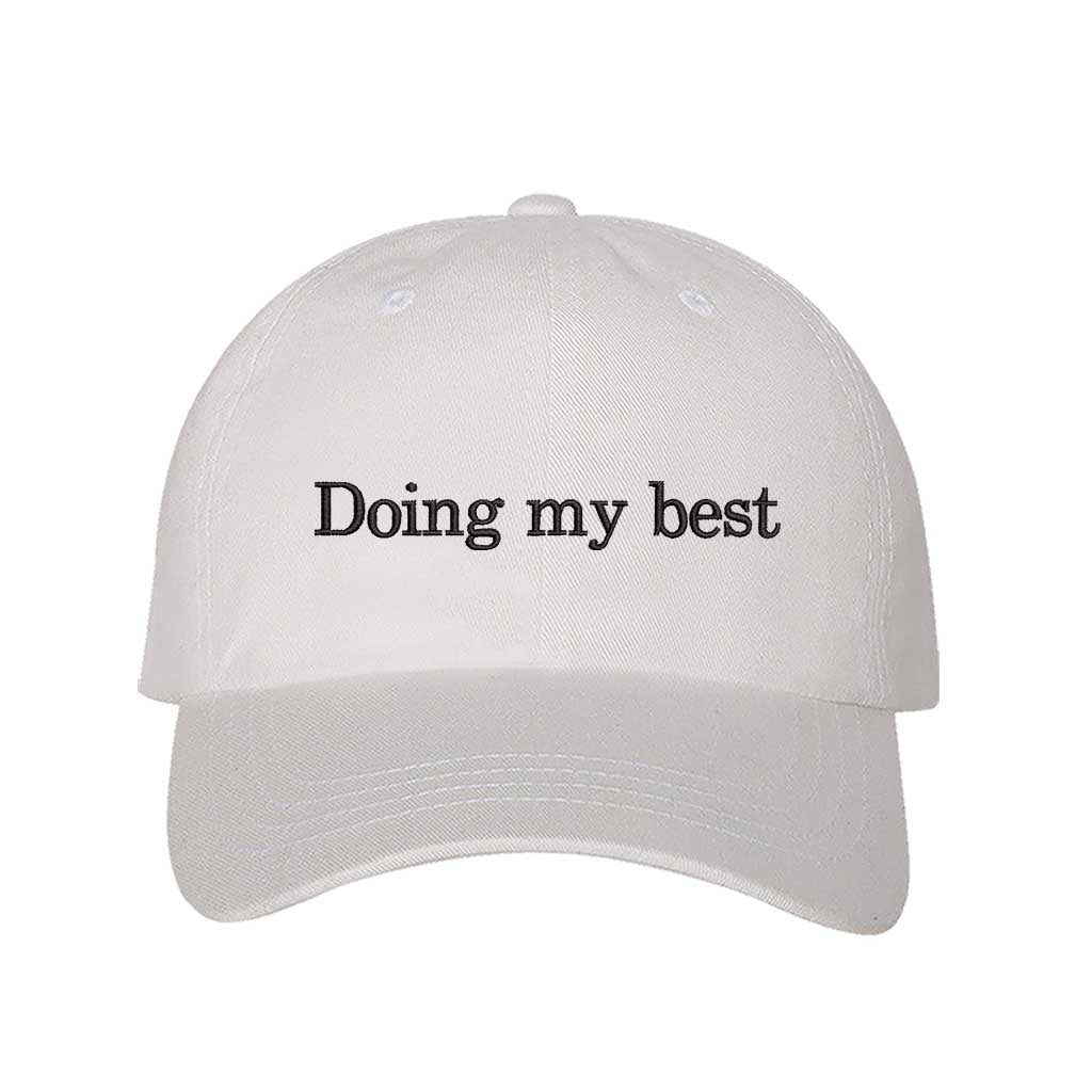White close-up view of a DSY Lifestyle cotton baseball hat featuring the words Doing My Best in detailed professional embroidery. - DSY Lifestyle