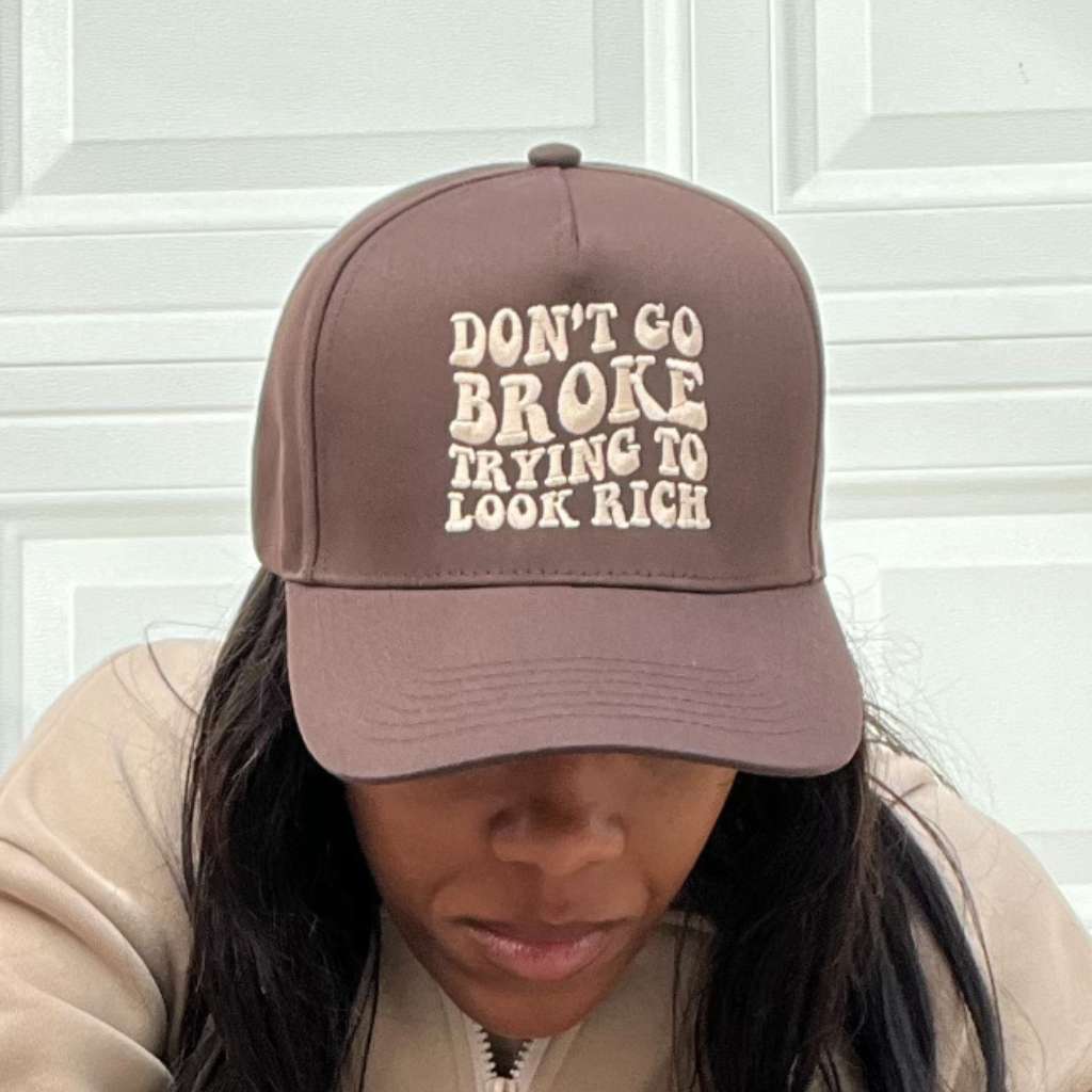 Woman wearing a solid brown embroidered baseball cap with Don&