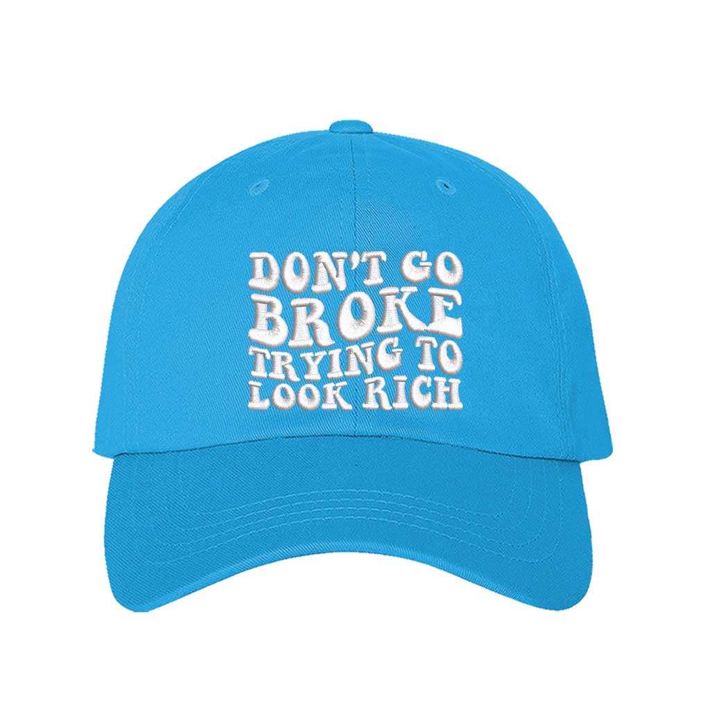 Aqua Don’t Go Broke Trying to Look Rich Embroidered Baseball Hat in soft cotton with curved brim and hook and loop closure. DSY Lifestyle.