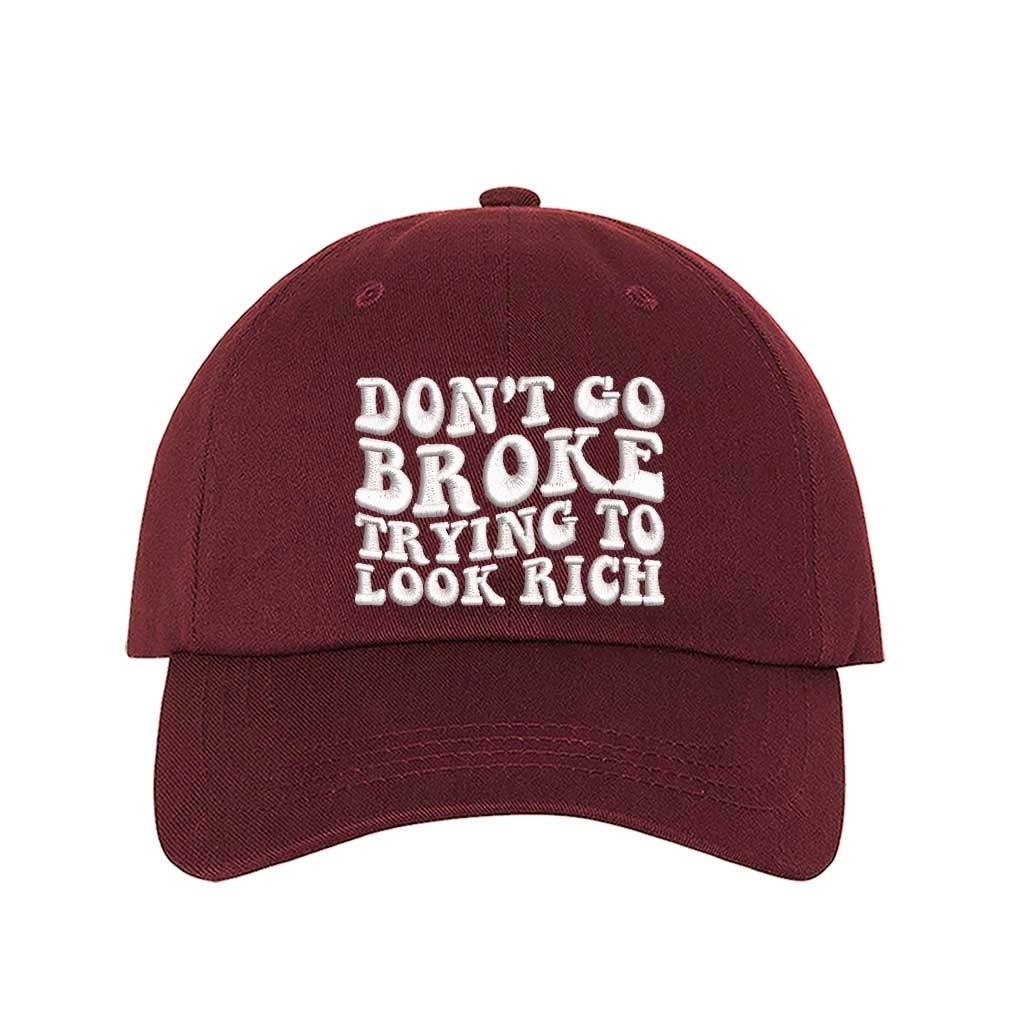 Burgundy Don’t Go Broke Trying to Look Rich Embroidered Baseball Hat in soft cotton with curved brim and hook and loop closure. DSY Lifestyle.