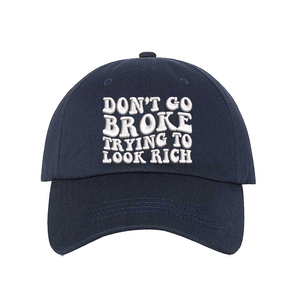 Navy Blue Don’t Go Broke Trying to Look Rich Embroidered Baseball Hat in soft cotton with curved brim and hook and loop closure. DSY Lifestyle.