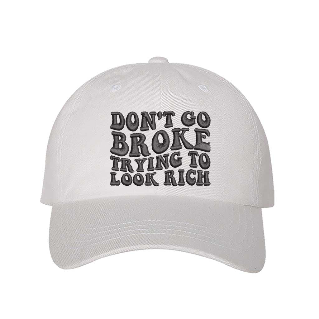 White Don’t Go Broke Trying to Look Rich Embroidered Baseball Hat in soft cotton with curved brim and hook and loop closure. DSY Lifestyle.