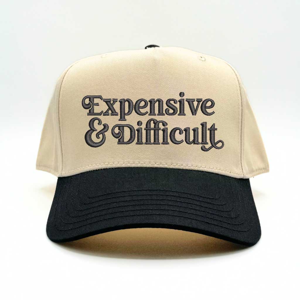 5 panel Natural color with black bill baseball hat embroidered with the phrase Expensive & Difficult -DSY Lifestyle
