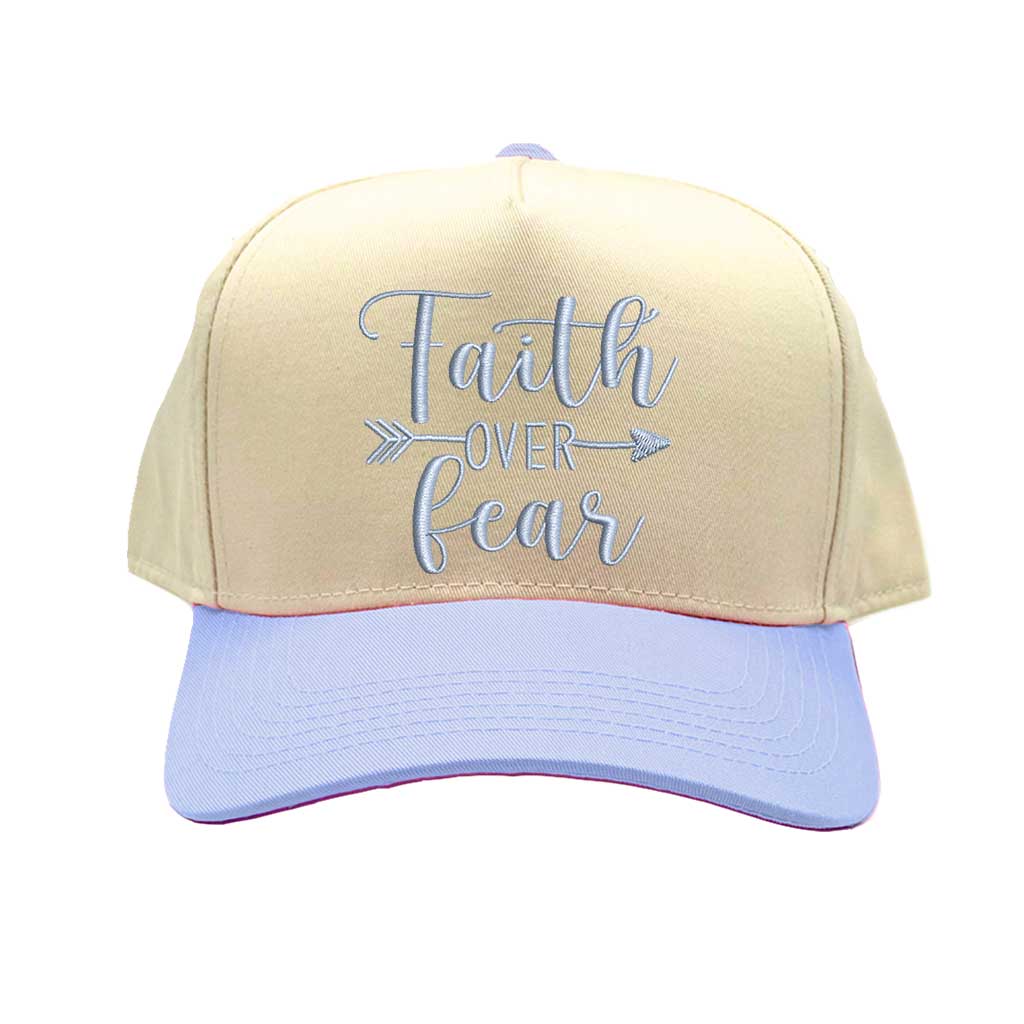 Natural Light Blue close-up view of a DSY Lifestyle two-tone baseball hat with a neutral crown and contrast bill, featuring the words Faith Over Fear in bold, detailed embroidery. - DSY Lifestyle