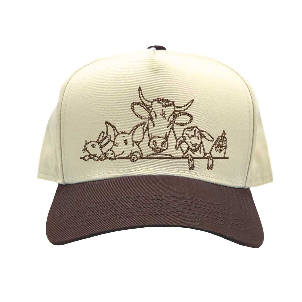 Natural Brown DSY Lifestyle two-tone baseball hat with a natural crown and contrasting bill, featuring an embroidered graphic of a cow, pig, and rooster family. - DSY Lifestyle