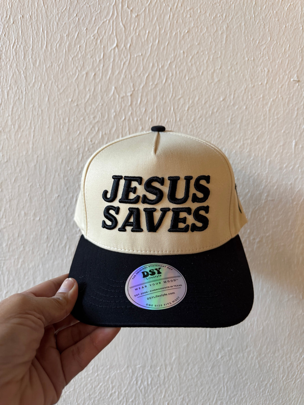 Jesus Saves embroidered two-tone trucker hat on a white background
