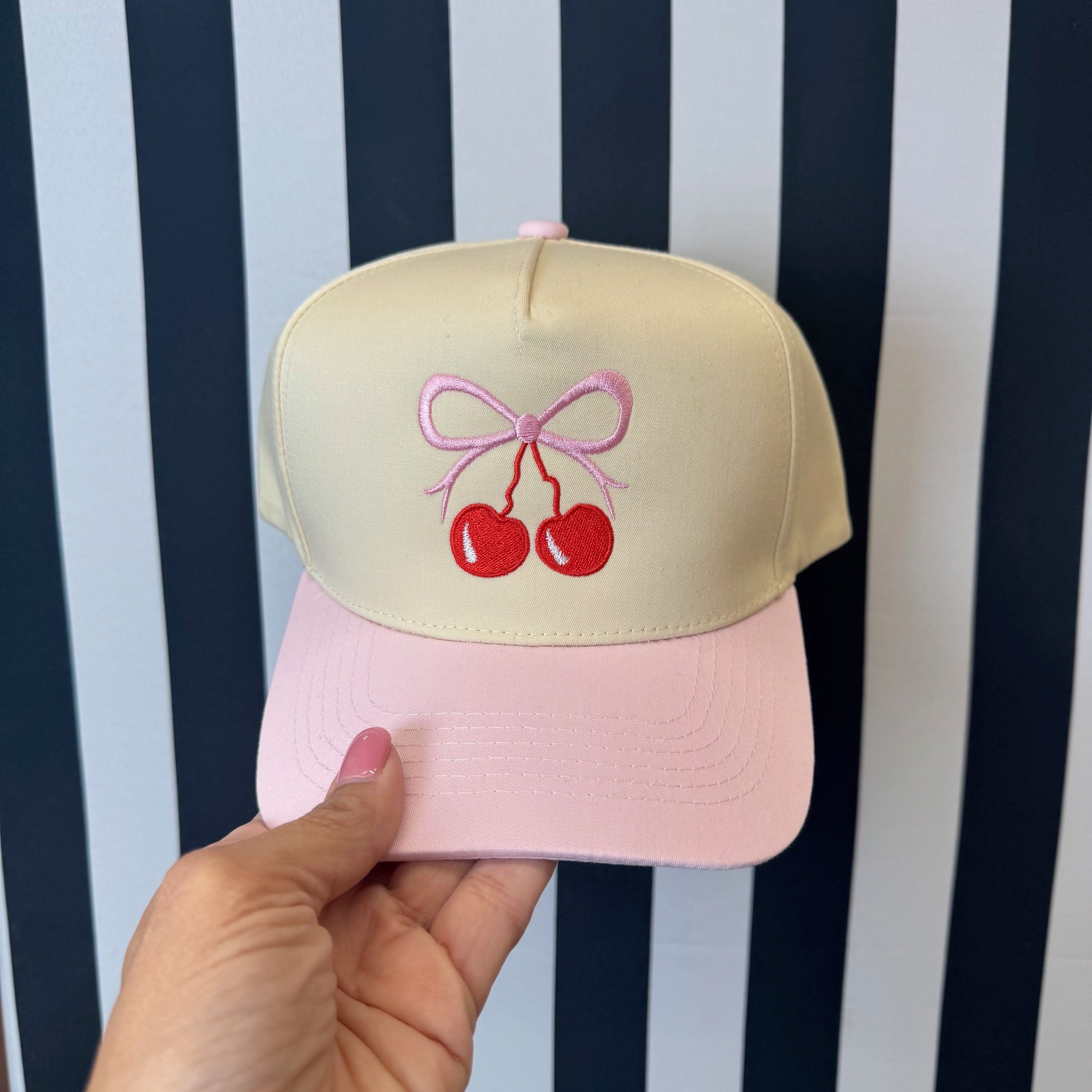 Natural colored 5 panel baseball hat with light pink bill embroidered with a cherry bow-DSY Lifestyle