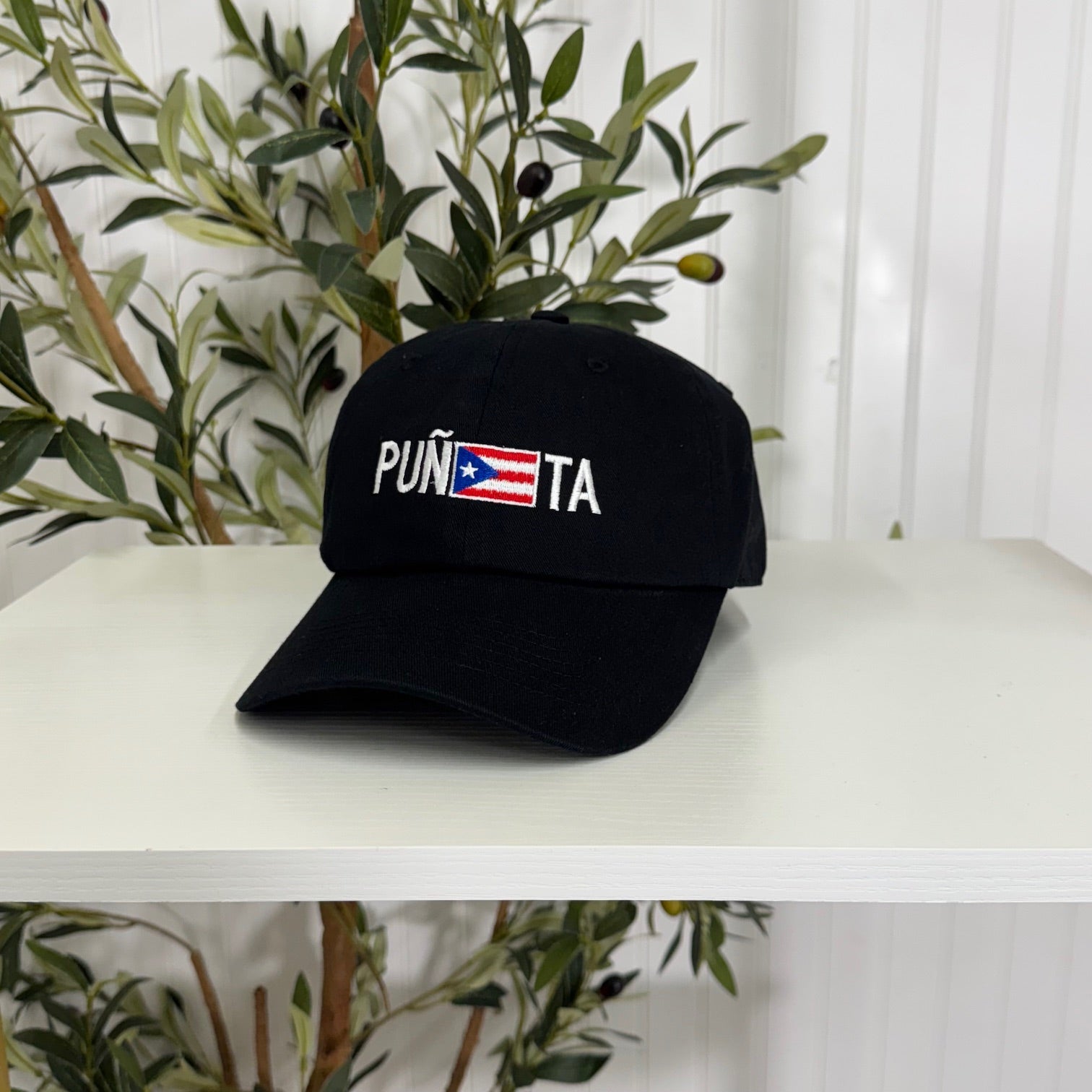 Black embroidered baseball hat with "Puñeta" in bold lettering, featuring the Puerto Rican flag as the letter "E," representing Boricua pride and culture - DSY Lifestyle