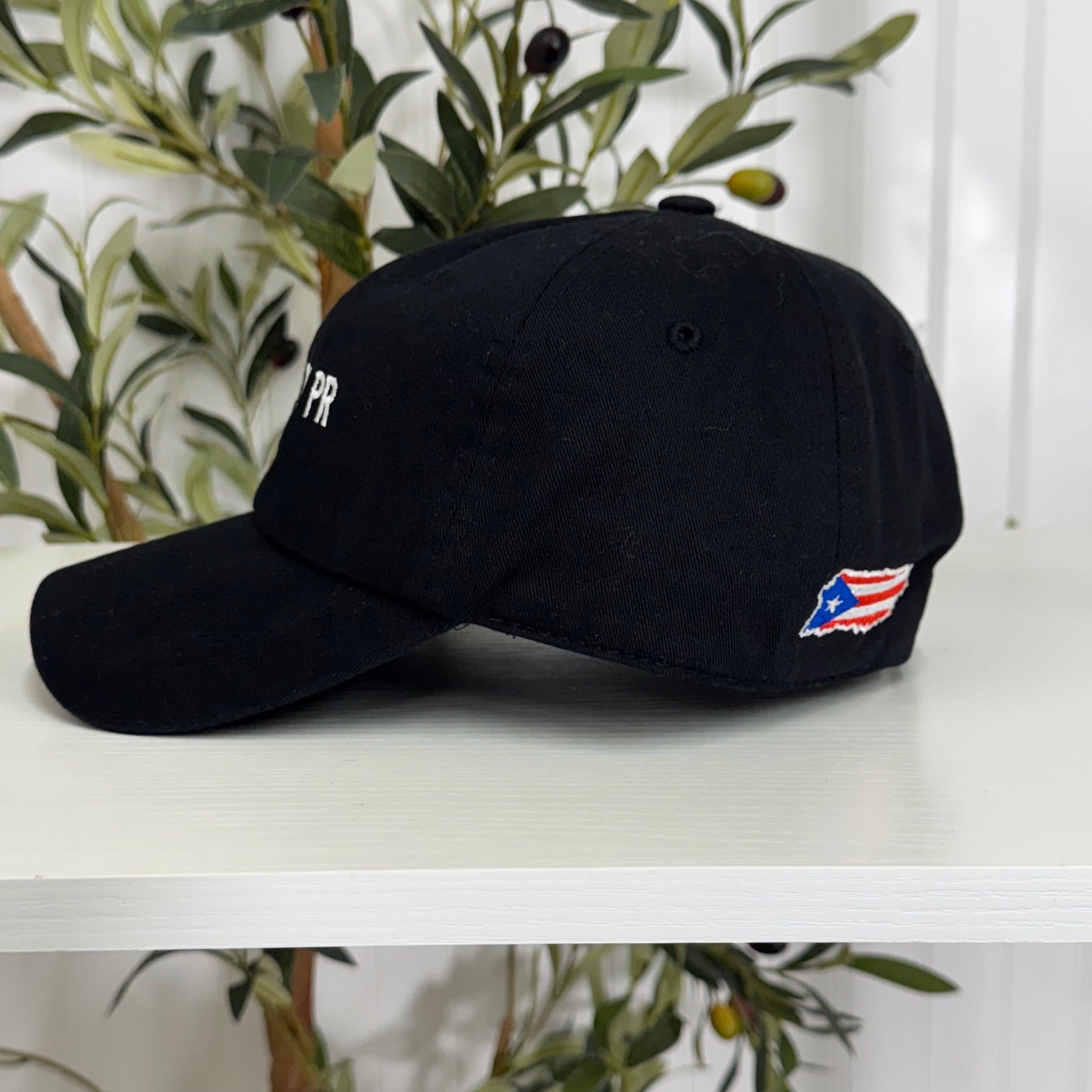 Black embroidered baseball hat side view with "Hecho En PR" stitched in bold lettering, representing Puerto Rican pride and heritage - DSY Lifestyle
