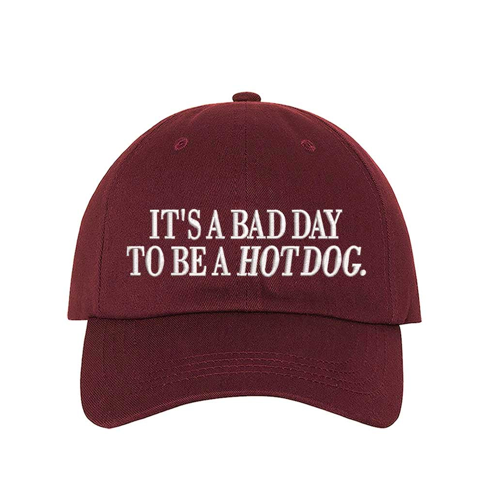 Burgundy embroidered baseball hat with the phrase “It’s a Bad Day to Be a Hotdog” — perfect for BBQs and summer parties. - DSY Lifestyle