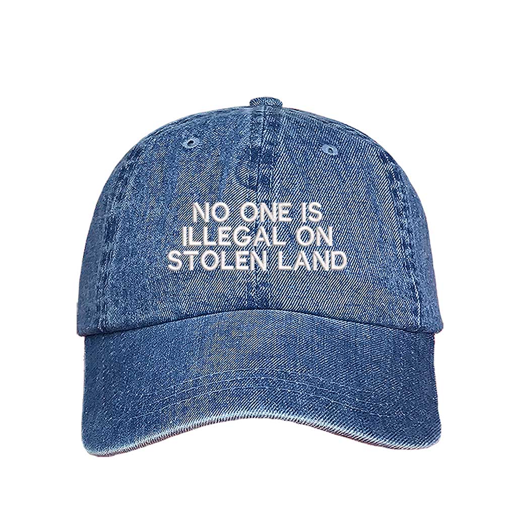 Light Denim No One Is Illegal On Stolen Land Baseball Hat featuring bold white embroidery on a classic cotton dad cap; a powerful social justice statement piece by DSY Lifestyle.