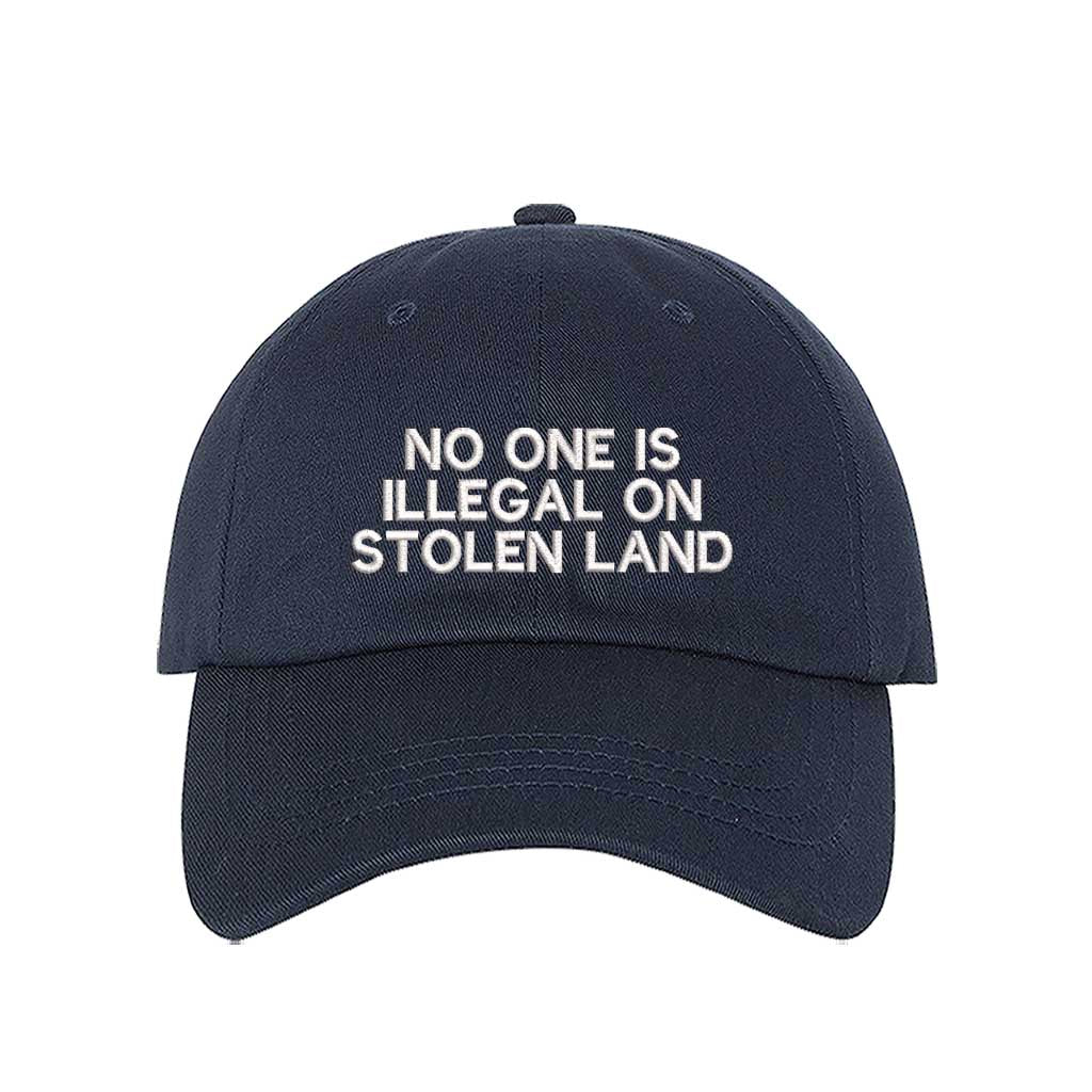 Navy Blue No One Is Illegal On Stolen Land Baseball Hat featuring bold white embroidery on a classic cotton dad cap; a powerful social justice statement piece by DSY Lifestyle.