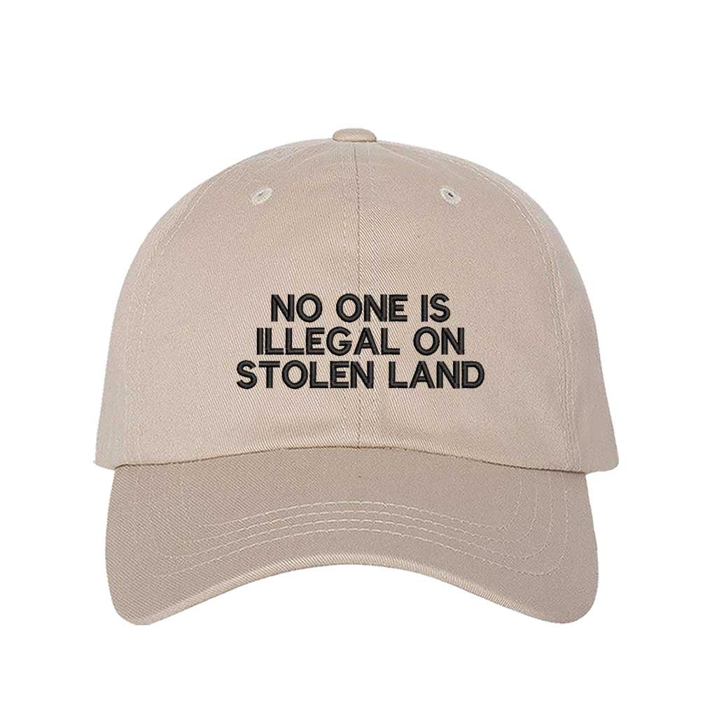 Stone No One Is Illegal On Stolen Land Baseball Hat featuring bold white embroidery on a classic cotton dad cap; a powerful social justice statement piece by DSY Lifestyle.