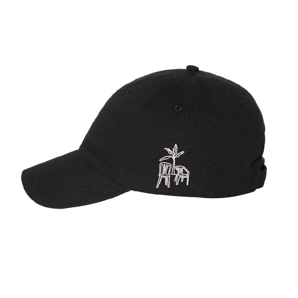 Black side view of a classic baseball hat featuring a detailed Debi Tirar Mas Fotos in high-density embroidery on the center crown. - DSY Lifestyle