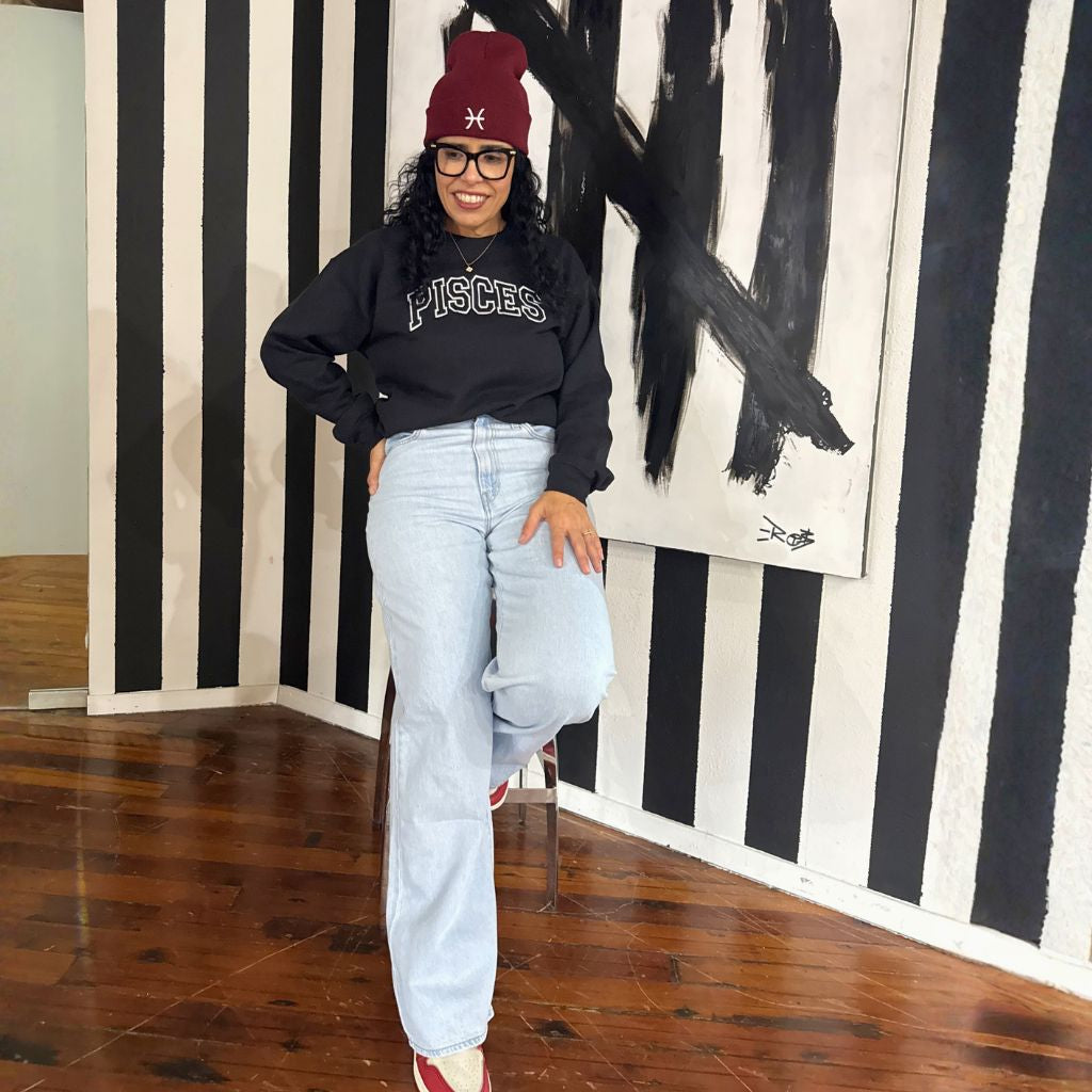 Daisy wearing a black embroidered Pisces&