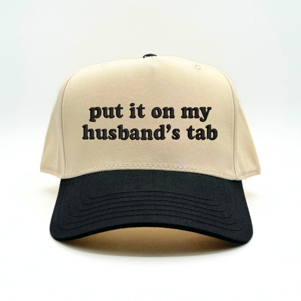 Flat lay of the Sorry About My Husband baseball cap with casual accessories