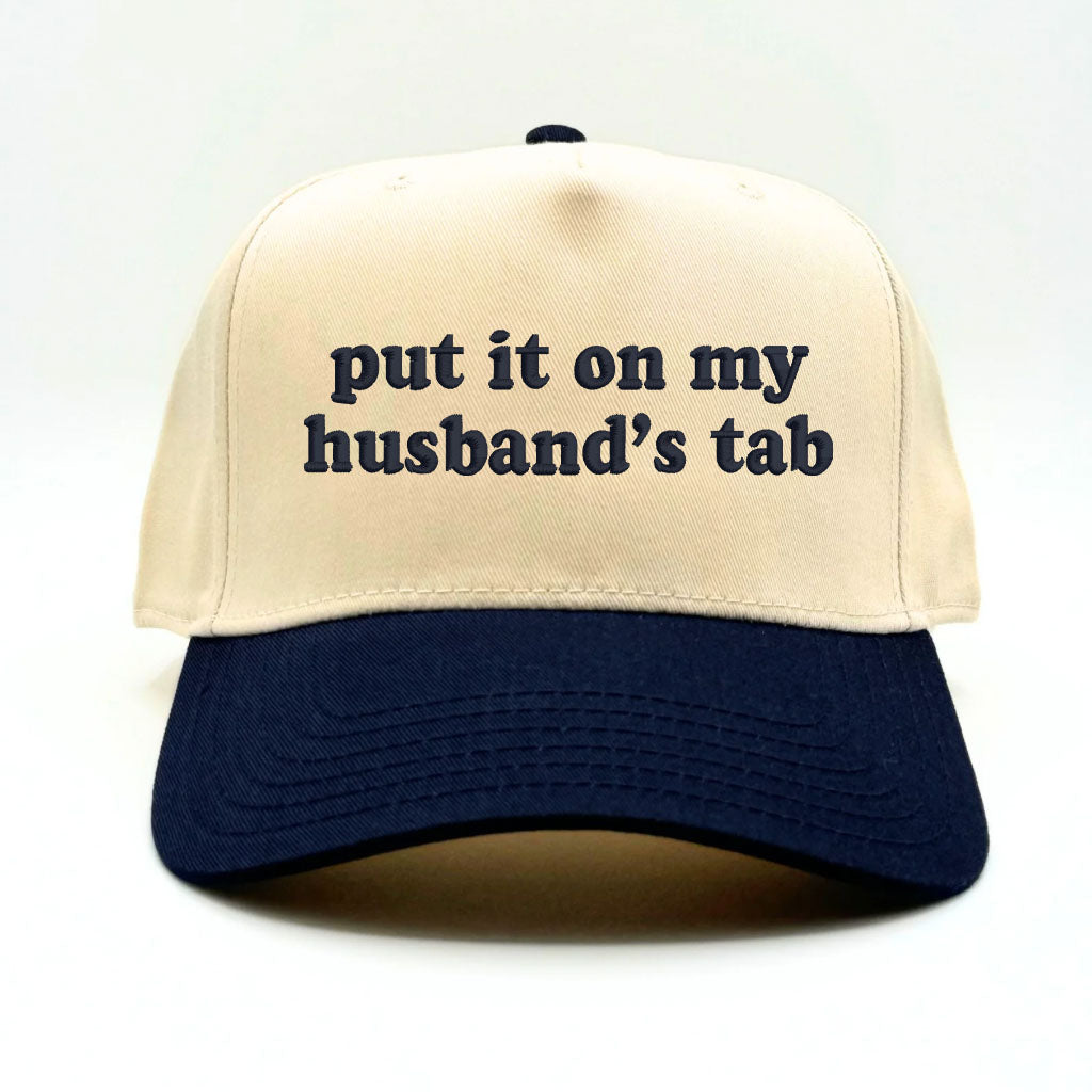 Flat lay of the Sorry About My Husband baseball cap with casual accessories