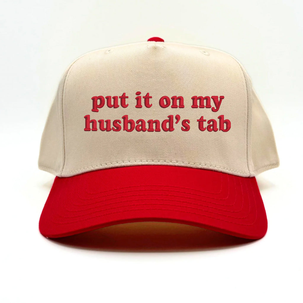 Flat lay of the Sorry About My Husband baseball cap with casual accessories