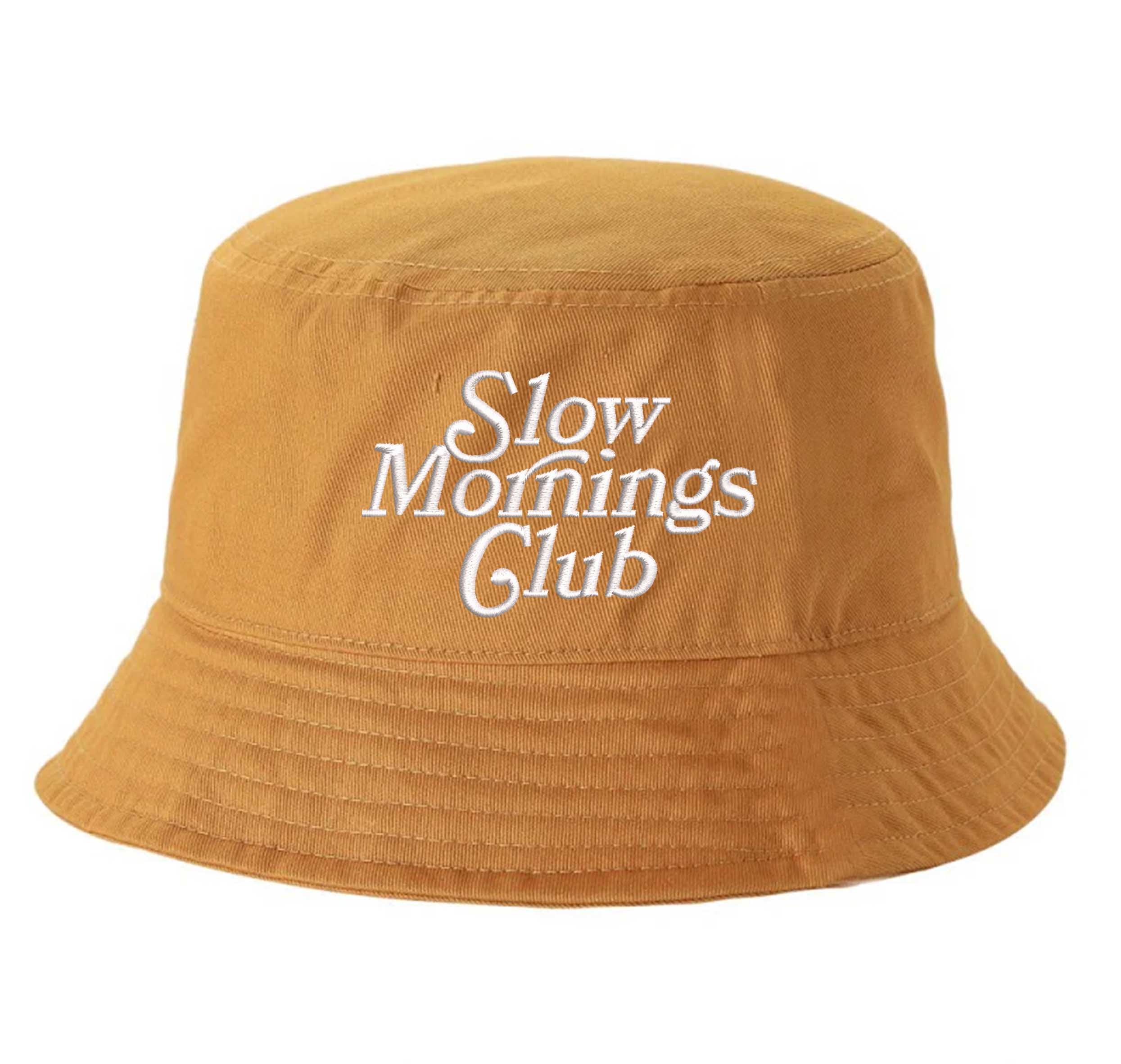 Mustard Front view of a classic cotton bucket hat featuring the phrase "Slow Morning" in high-density script embroidery. - DSY Lifestyle
