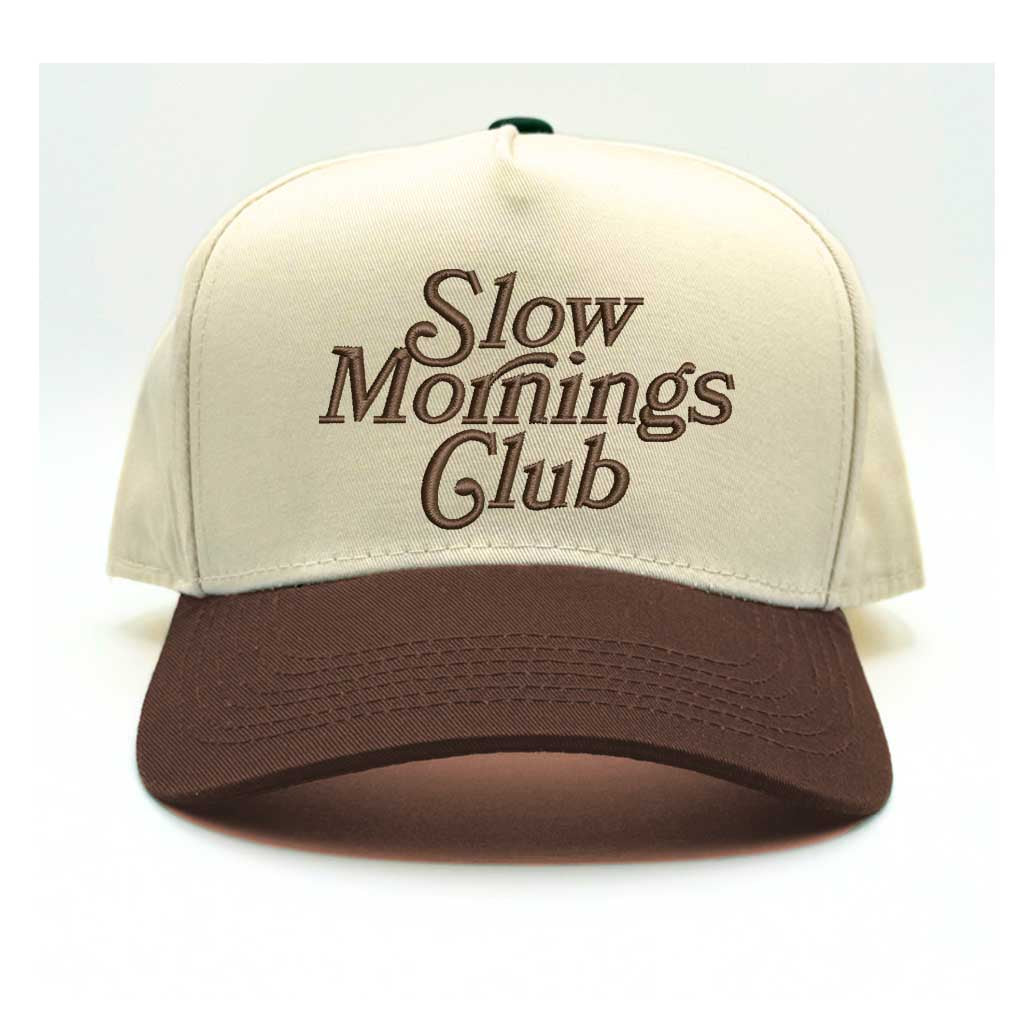 Beige and brown 5-panel baseball hat with "Slow Mornings Club" embroidered by DSY Lifestyle in brown on the front.