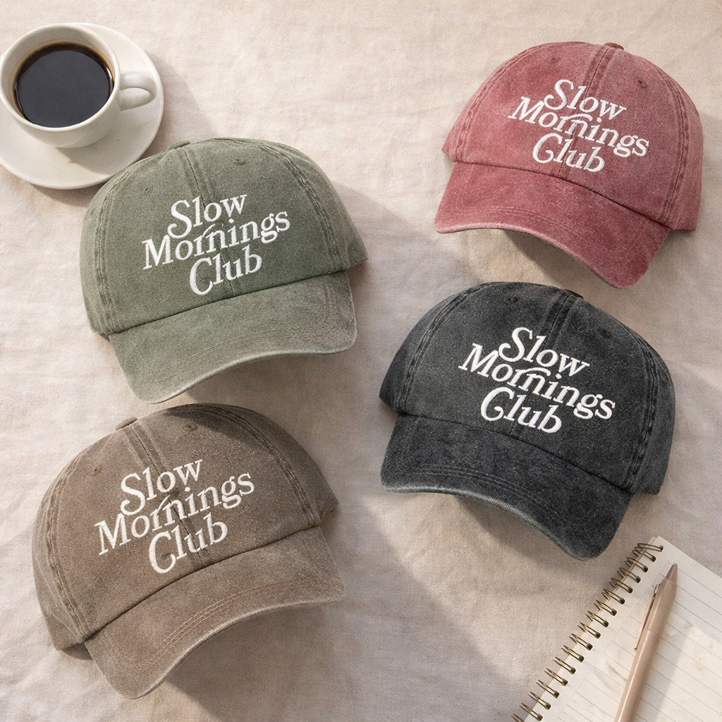 Flat lay Olive, Wine, Chocolate Brown, and Black Slow Mornings Club washed cotton baseball hats with a soft, lived-in finish and premium high-density embroidery by DSY Lifestyle. - DSY Lifestyle