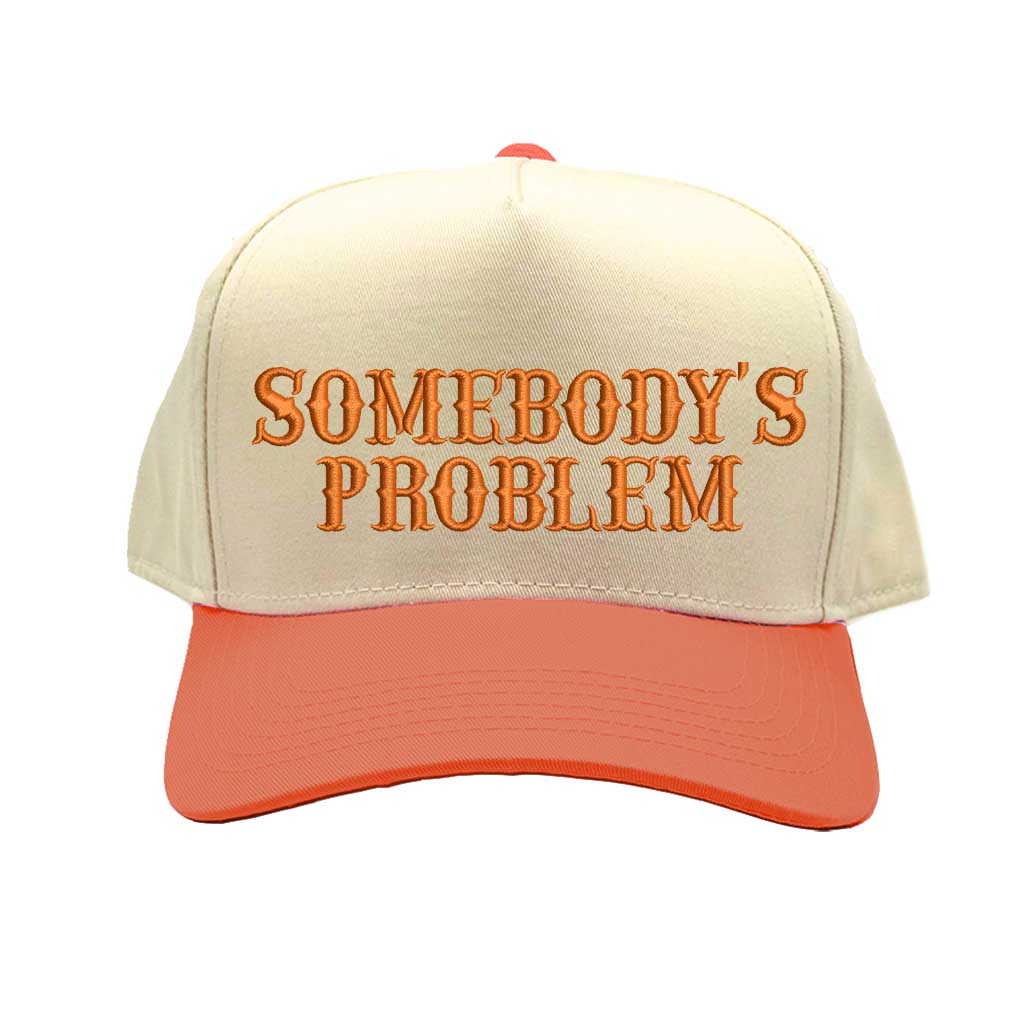 Natural Orange two-tone 5 panel Somebody’s Problem embroidered dad hat with white front panel, beige brim, bold black text, and adjustable strap. – DSY Lifestyle.