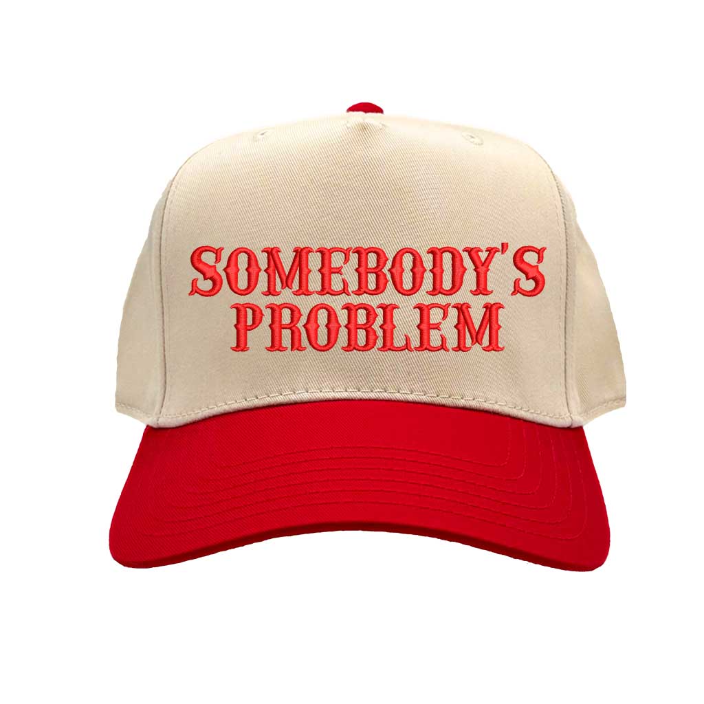 Natural Red two-tone 5 panel Somebody’s Problem embroidered dad hat with white front panel, beige brim, bold black text, and adjustable strap. – DSY Lifestyle.