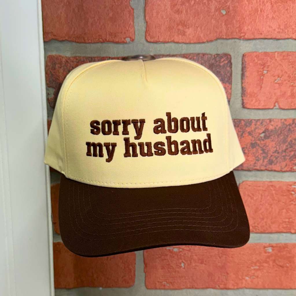 Close-up of embroidered Sorry About My Husband text on the cap&