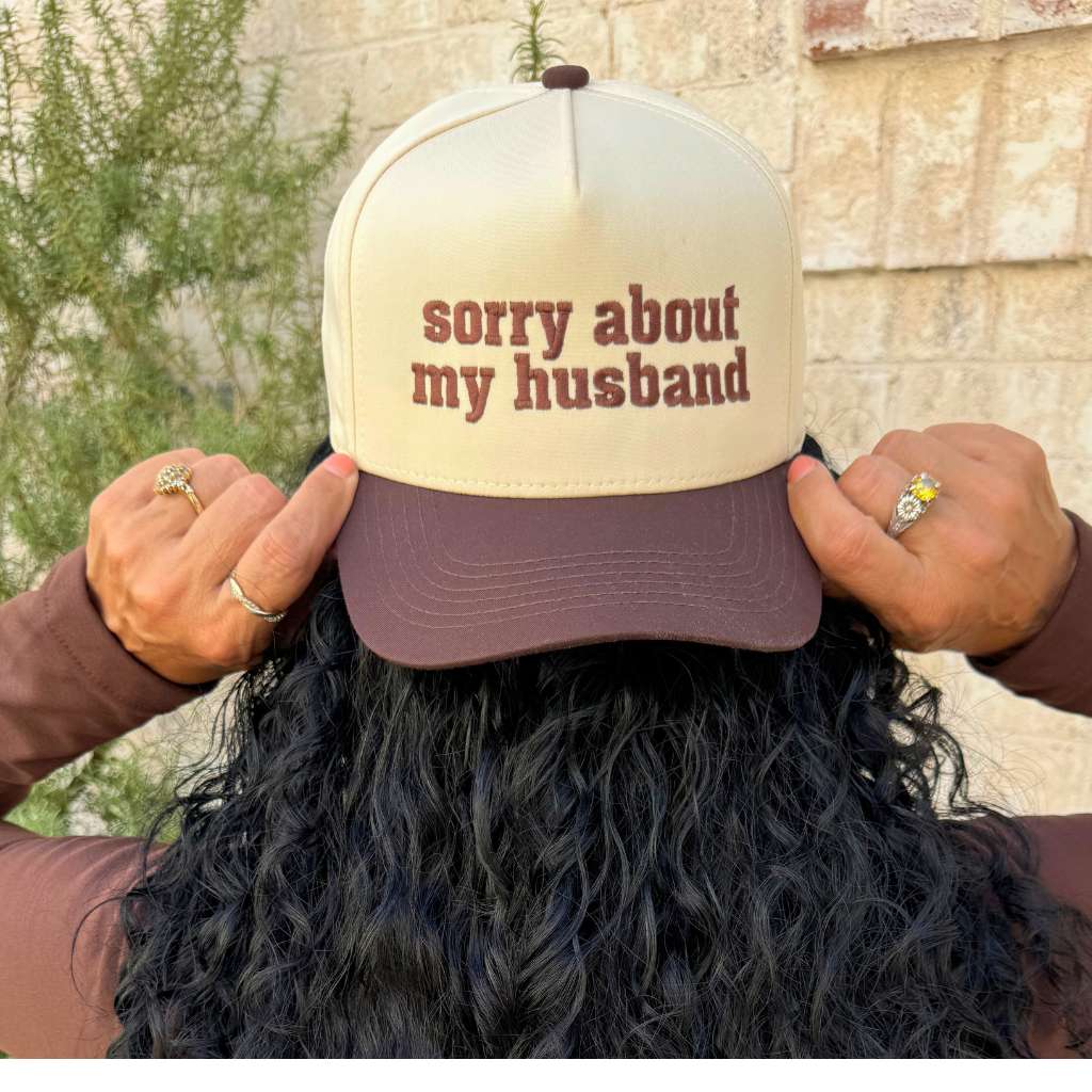 Front view of the Sorry About My Husband 5-panel baseball hat with natural crown and brown bill