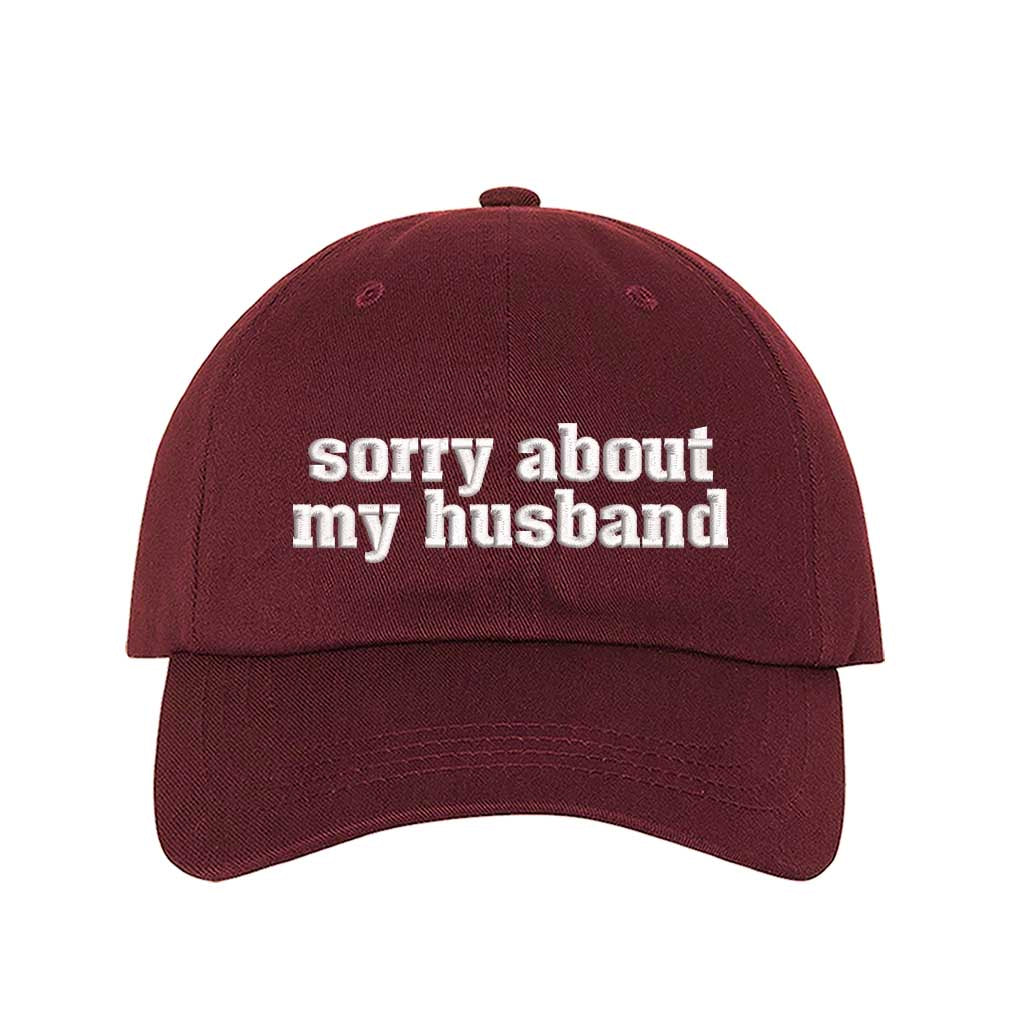 Burgundy Sorry About My Husband Embroidered Baseball Hat in classic cotton dad cap style with curved brim and hook and loop closure. DSY Lifestyle.