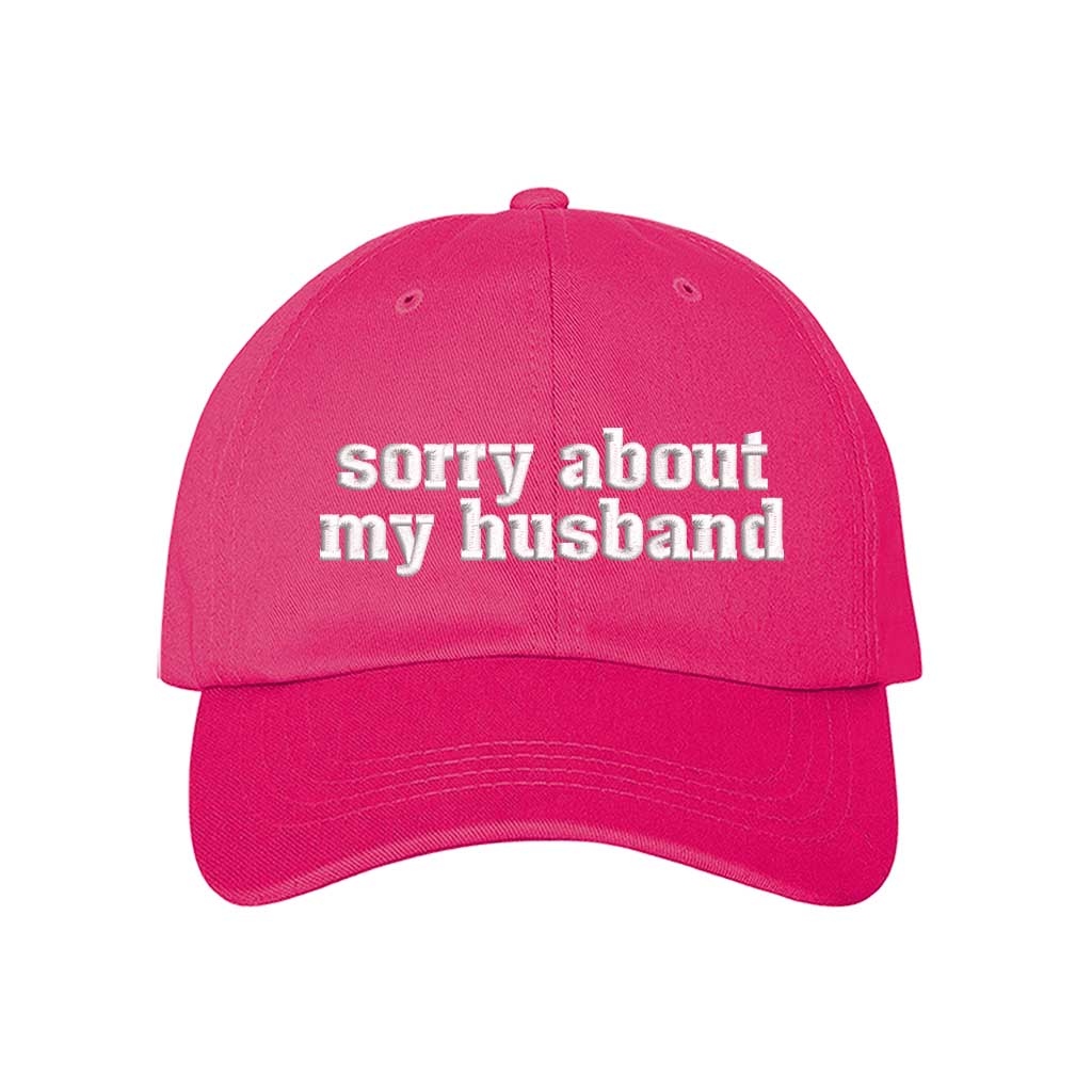 Hot Pink Sorry About My Husband Embroidered Baseball Hat in classic cotton dad cap style with curved brim and hook and loop closure. DSY Lifestyle.
