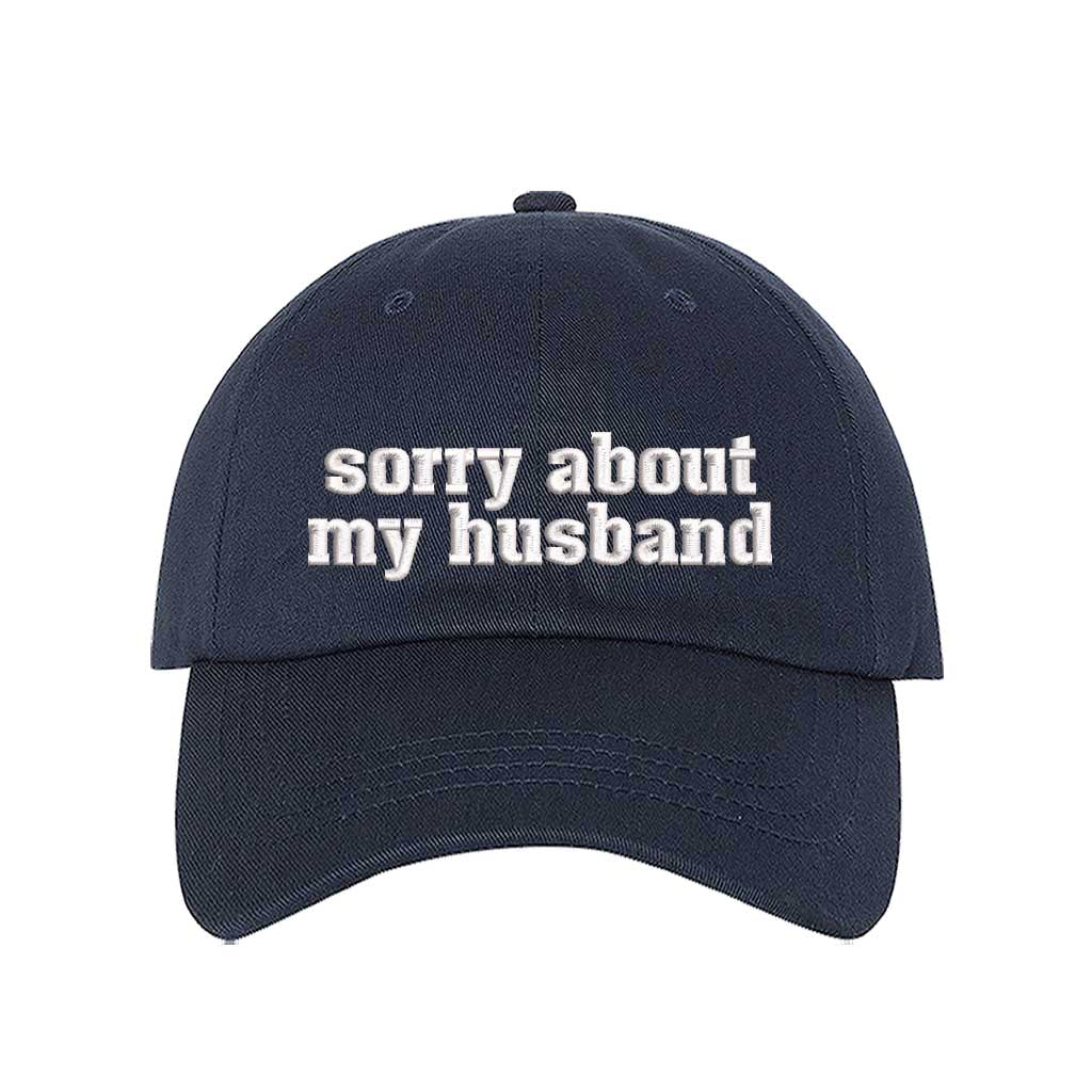 Navy Blue Sorry About My Husband Embroidered Baseball Hat in classic cotton dad cap style with curved brim and hook and loop closure. DSY Lifestyle.