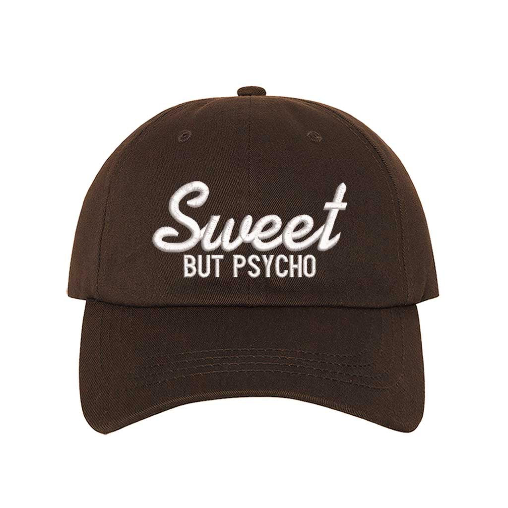 Brown Close-up of a DSY Lifestyle baseball hat with "Sweet But Psycho" embroidered in a clean, modern font; a funny statement gift for her.